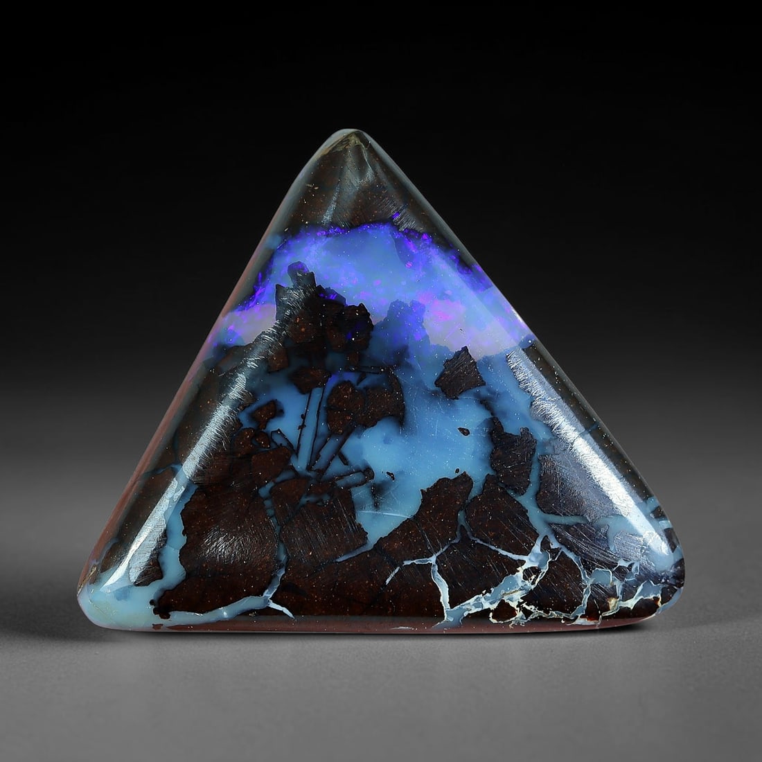 9.46ct Natural Australian Queensland Matrix Boulder Opal Triangular Cabochon, 46AV: Hand polished symmetrical rounded triangle cabochon crafted from natural Queensland matrix boulder opal, featuring deep rich brown ironstone host partially engulfed by a vast luminous sky-blue opal po