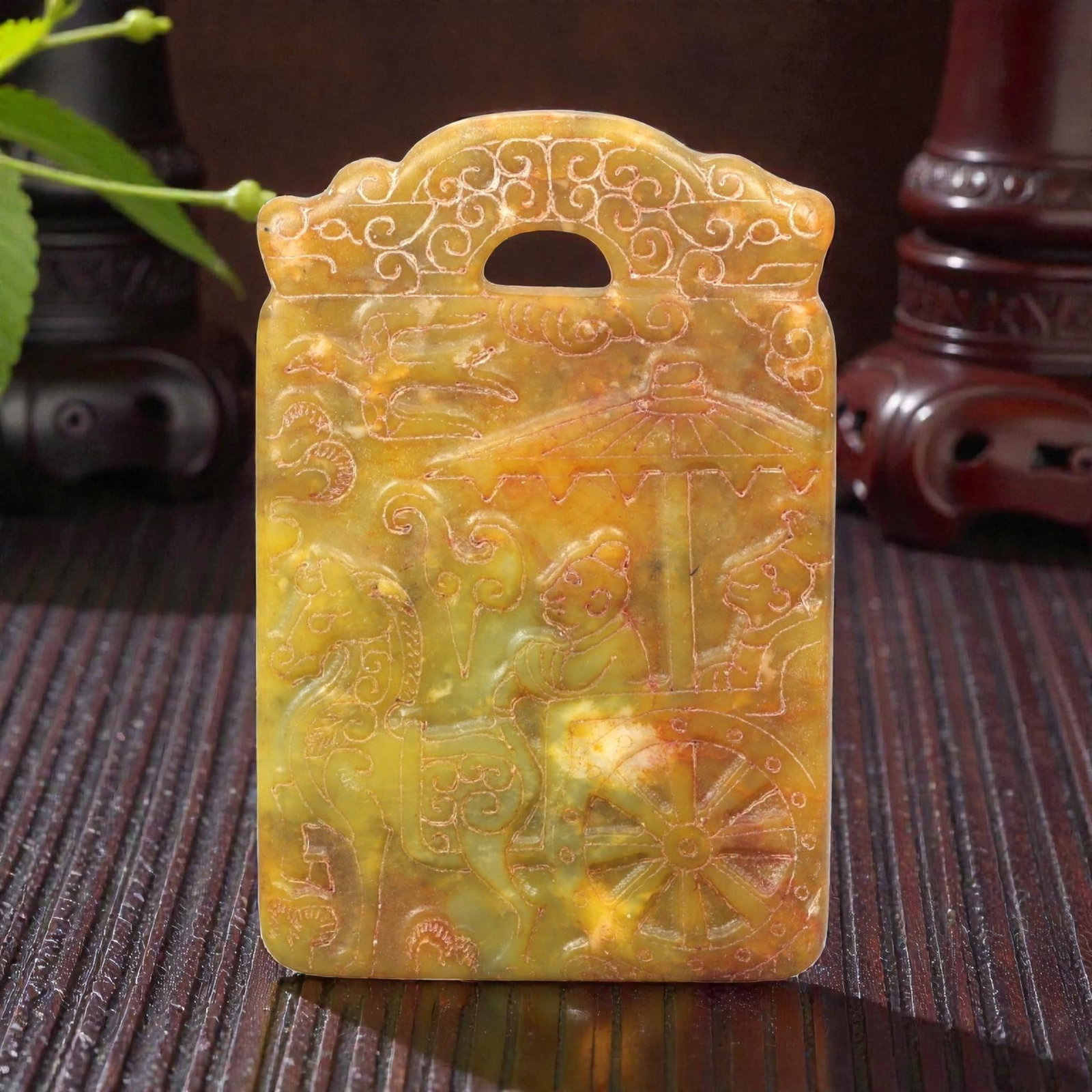 A Chinese Archaistic-Style Jade Figural Plaque, 20th Century, 45FH: Carved from yellow-green jade with mottled tonal variation, areas of russet staining, and natural inclusions, the plaque is rectangular in form with a scalloped upper edge and a pierced aperture for s
