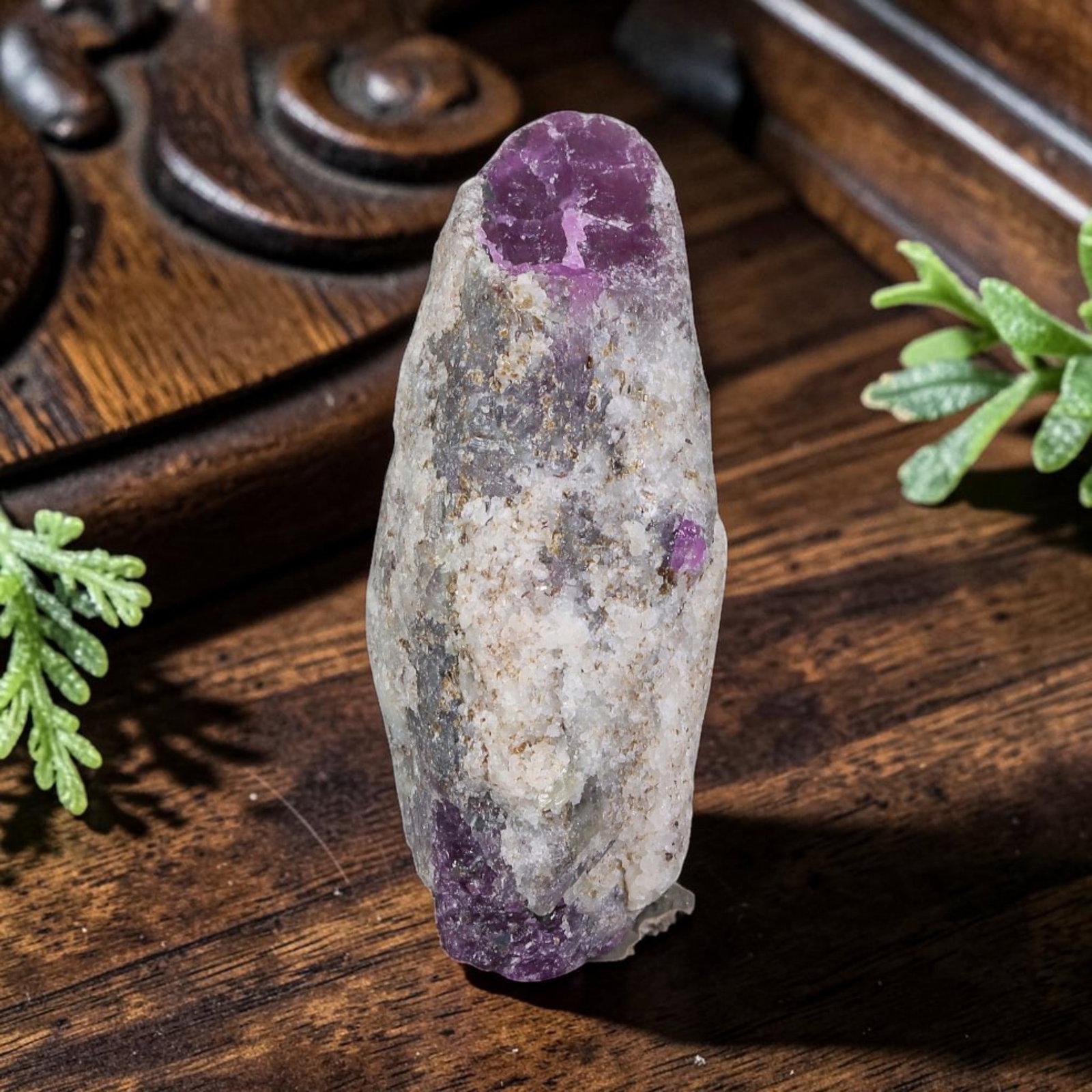 29.41ct Natural Mauritania Ruby Rough (Unheated), 63AT: Natural unheated corundum rough extracted from Mauritanian gem-bearing strata, presenting an elongated spindle crystalline shape with distinct saturated magenta ruby corundum deposits concentrated at 