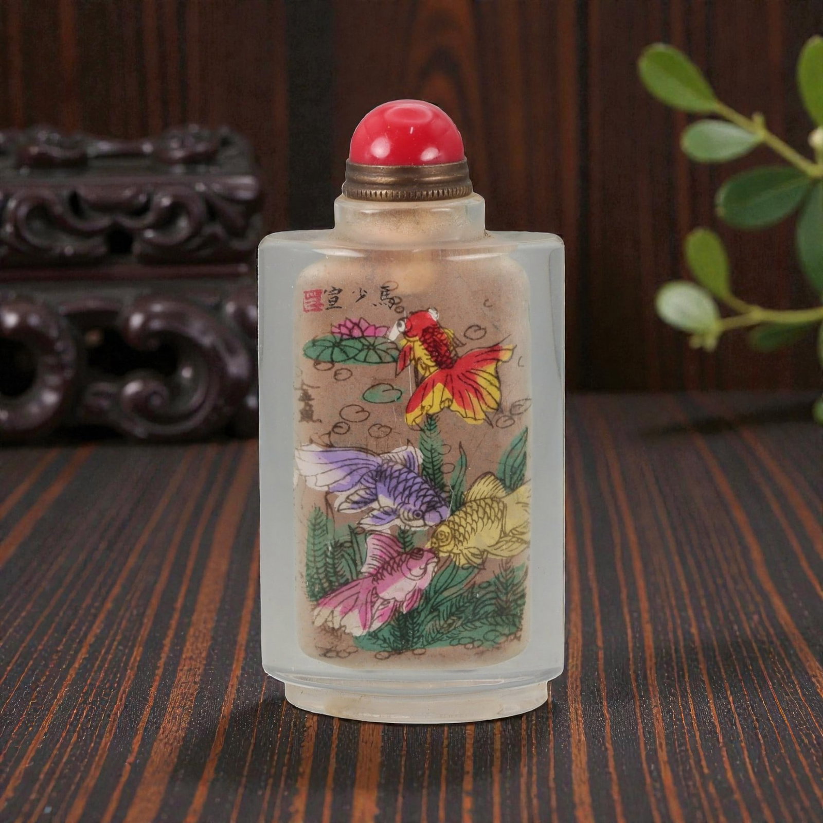 A Chinese Crystal Glass Inside-Painted Snuff Bottle, 20th Century, 57FG: The snuff bottle is formed from clear crystal glass and of flattened rectangular section, rising from a narrow recessed foot to a short cylindrical neck with a flat rim. The interior is painted with a