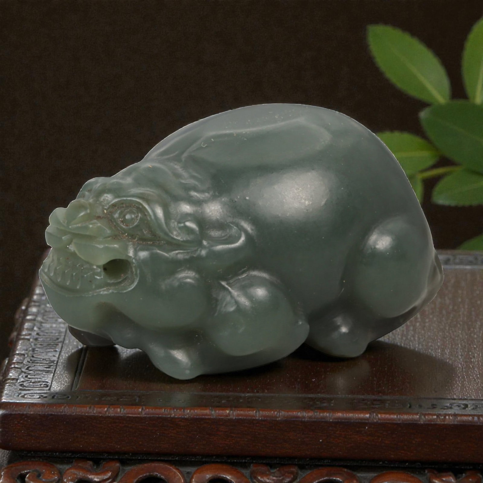 Chinese Jade Pixiu Beast - Carved Stone Animal, 58ZD: Carved from translucent green jade with soft tonal variation, this compact pixiu is modeled in a crouching pose with rounded haunches, a stylized head, and lightly incised details defining the eyes, m