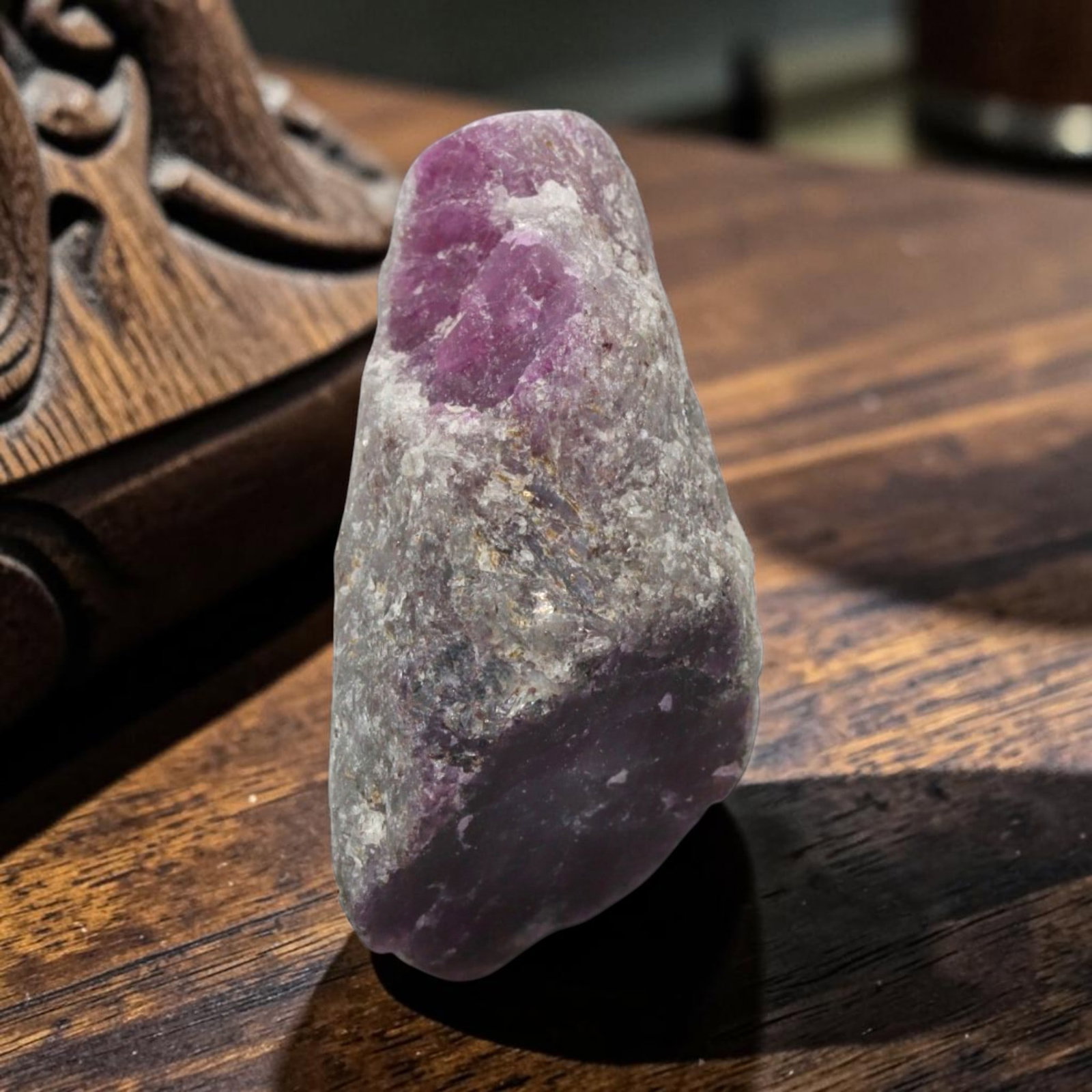 16.48ct Natural Mauritania Ruby Rough (Unheated), 65XE: This unheated Mauritania ruby rough is a captivating natural crystal specimen, featuring vivid magenta-purple ruby formations embedded in a contrasting greyish matrix. The stone's rugged, unpolished s