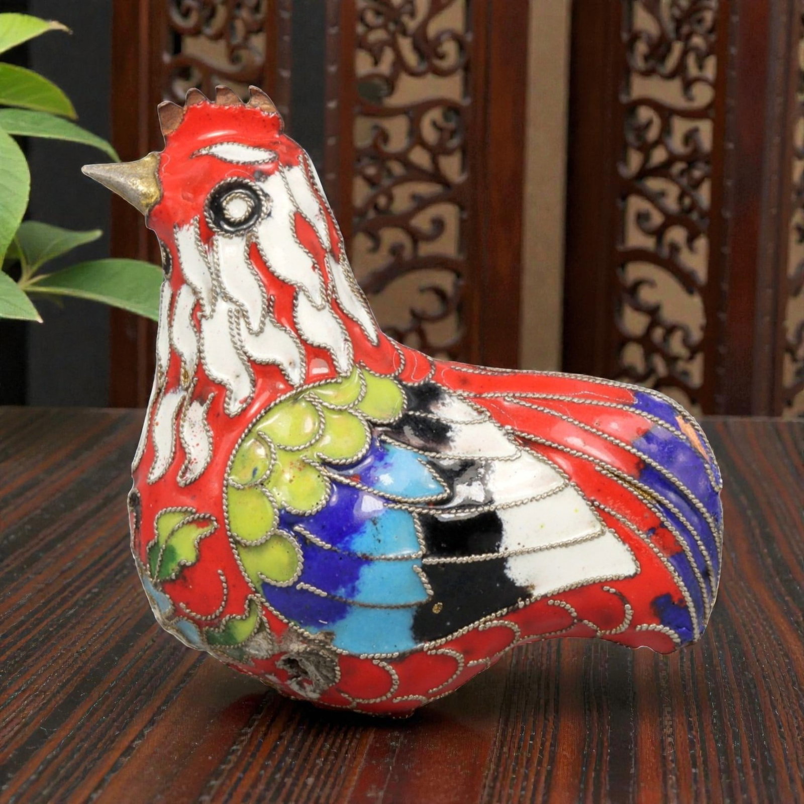 A Chinese Cloisonne Enamel Rooster Effigy, 20th Century, 79YC: Constructed in copper and decorated with polychrome cloisonne enamel, the figure represents a stylized rooster shown seated with an upright neck and compact body. The surface is densely ornamented wit
