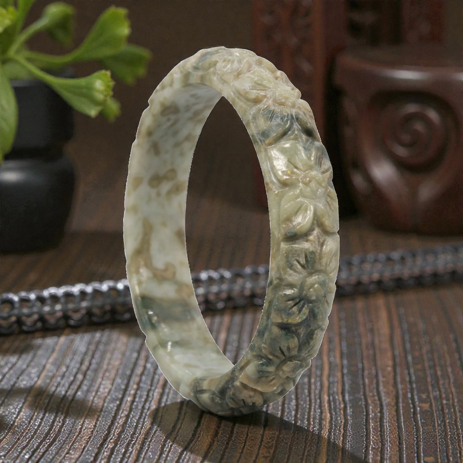 Natural Burmese Type A Carved Jadeite Jade Bangle Bracelet, 20th Century, 79ZL: A fine jadeite bangle of flattened circular form, masterfully carved in relief with a continuous band of chrysanthemum blossoms. The stone exhibits a striking variegated palette, with a pale milky-gre