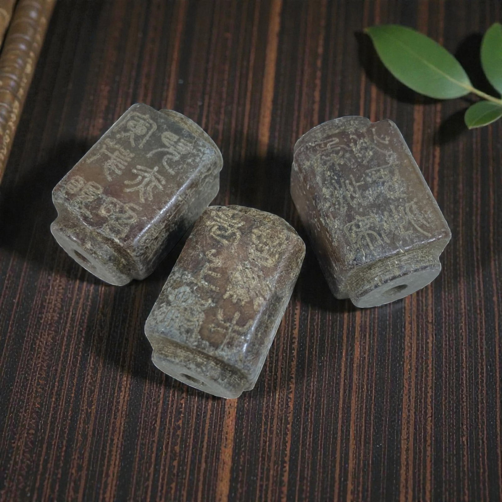 A Lot of 3 Antique Chinese Agate Beads with Inscriptions, 59AB: The group comprises three antique Chinese agate beads of a square-tubular form, exhibiting warm brown and reddish tones with natural inclusions and age-related patina. Each bead is fully perforated an