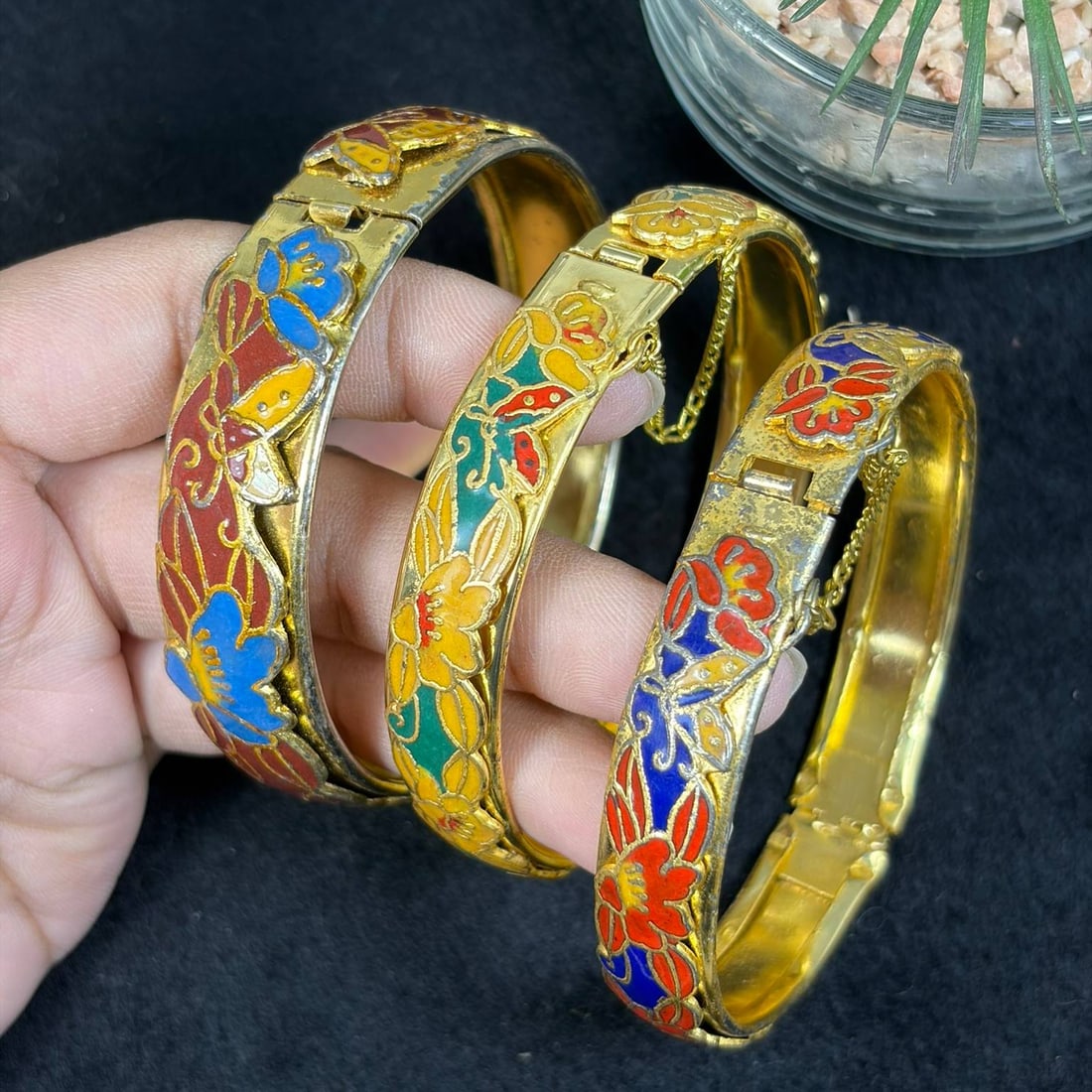 Lot of 3 Vintage Gold Tone Floral Cloisonne Hinged Bangle Bracelets with Safety Chain, 17EB: Set of 3 vintage cloisonne bangles with golden base, decorated with vibrant colorful floral cloisonne enamel filigree patterns; each features a hinged opening with attached safety chain for easy wear 