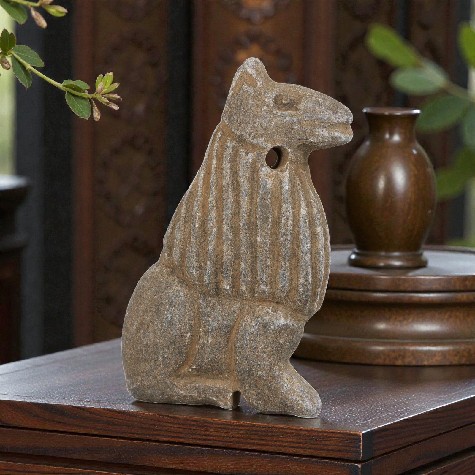 Ancient Near Eastern Stone Feline Amulet, 63YD: This ancient amulet is carved from grey stone, depicting a seated stylized feline with incised vertical lines across its torso, and a suspension hole at the neck. The carving is bold and schematic, ch