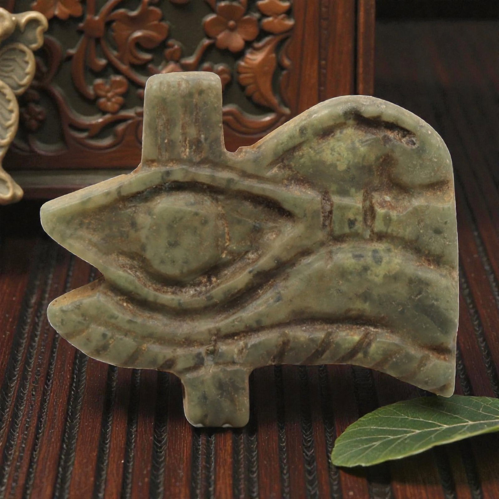 Ancient Serpentine Wedjet Eye Amulet - Egyptian Figurine, 88ZP: This artifact is a carved serpentine Wedjet Eye amulet, executed in the iconic protective tradition of ancient Egypt. The amulet depicts the Wedjet (or Eye of Horus) with distinct incised details: a c