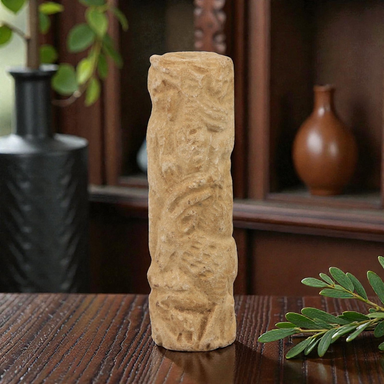 Ancient Limestone Cylinder Bead - Carved Relief Figurine, 8AH: Carved from limestone, this ancient cylinder bead features a slender, tubular form with raised relief detailing depicting a stylized humanoid figure, typical of ornamental use in early cultural contex