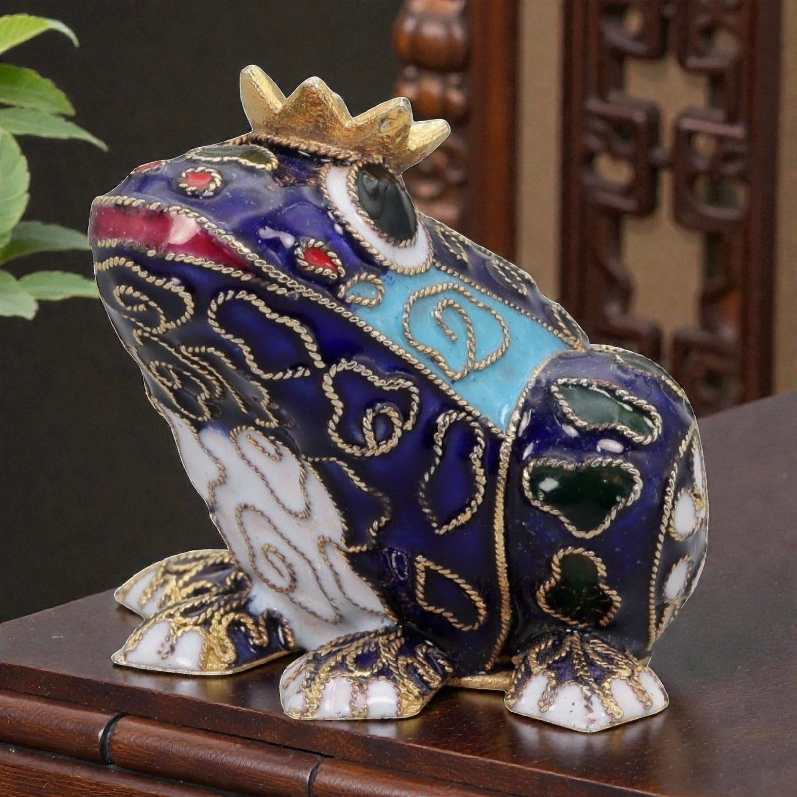 A Chinese Cloisonne Enamel Frog Effigy, 20th Century, 8FH: Modeled as a seated frog with the body upright and head raised, the effigy is constructed over a metal core and decorated overall with cloisonne enamel on a deep cobalt blue ground, the surface densel