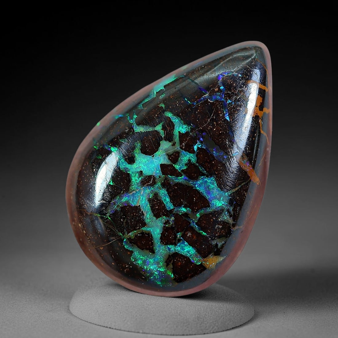 5.69ct Natural Australian Queensland Matrix Boulder Opal Cabochon, 19AV: Hand polished petite teardrop pear cabochon crafted from natural Queensland matrix boulder opal, featuring dark speckled ironstone host rock crisscrossed with vivid branching neon turquoise and electr