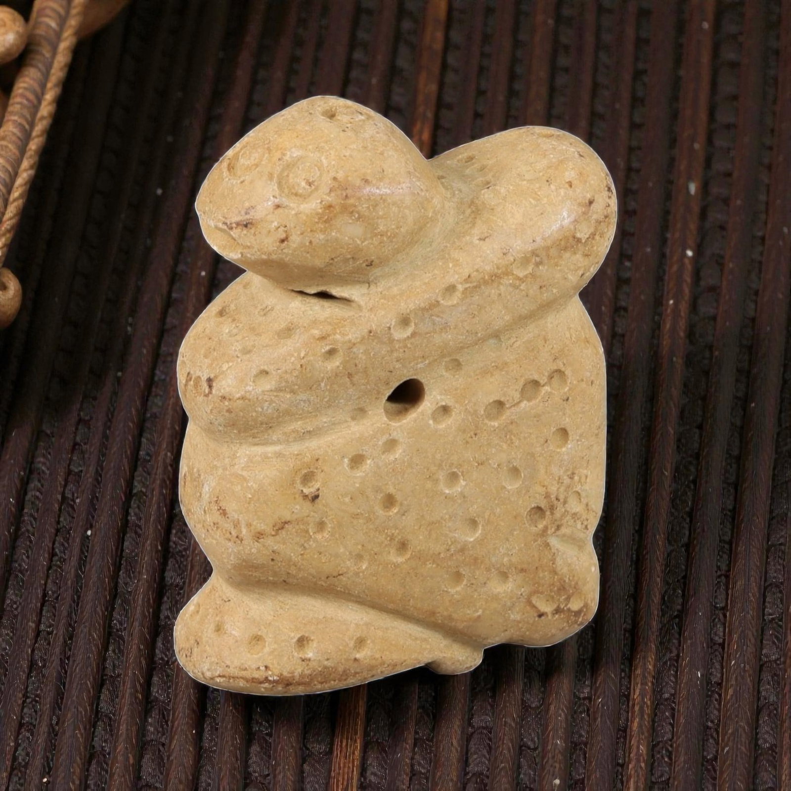 Ancient Stone Anthropomorphic Amulet - Near Eastern Carved Figurine, 56BA: Carved from light-colored hardstone, this amulet takes the form of a stylized anthropomorphic (humanoid) figure, rendered in three dimensions with simplified, bold carving. The figure is decorated wit