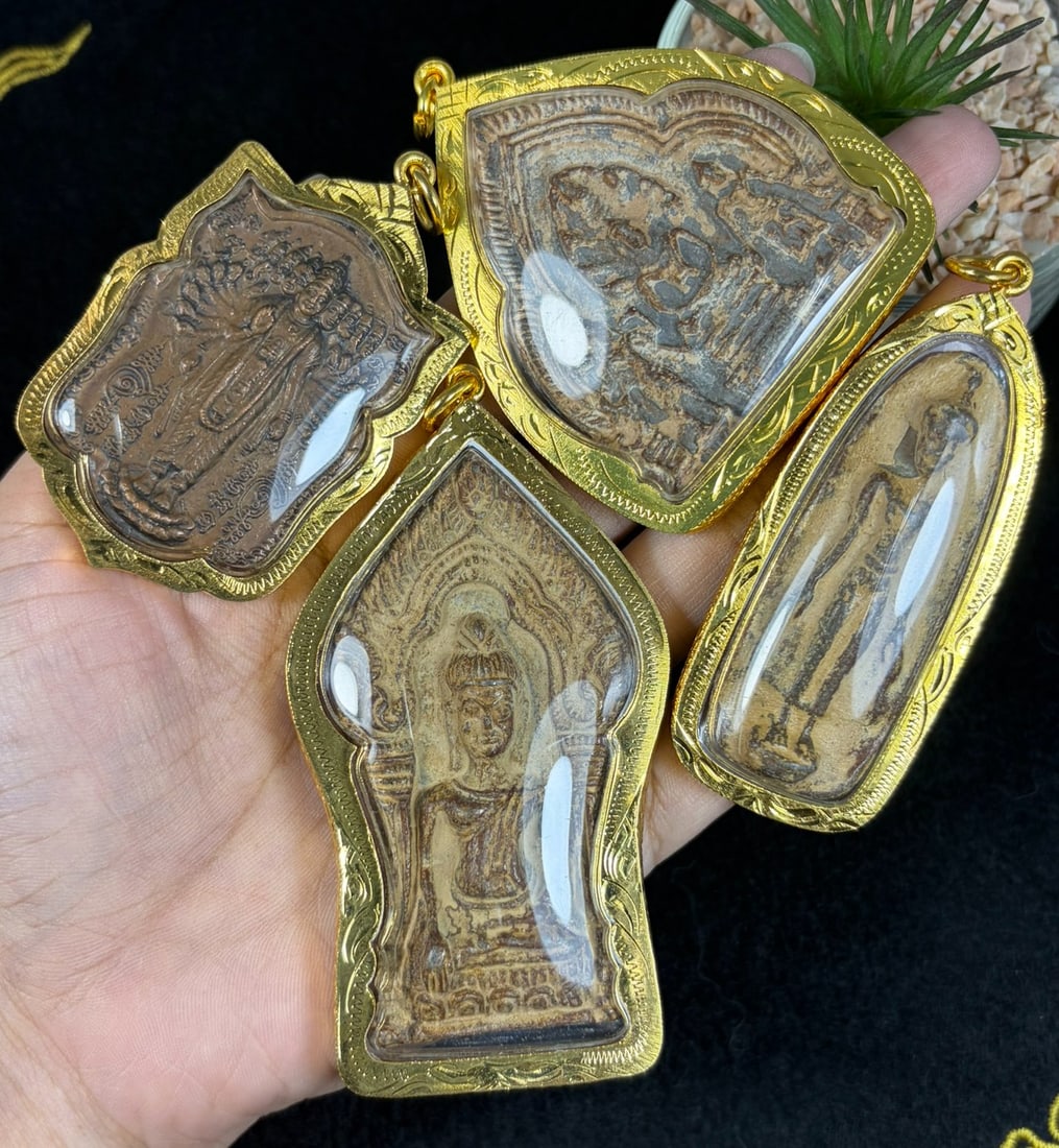 Vintage Thai Gilt Cased Buddha Amulets - 4 Piece Religious Lot, 66AR: This four-piece set contains vintage Thai Buddhist votive amulets encased within untested gilt metal protective frames fitted with clear viewing panels and integrated top suspension loops for pendant 