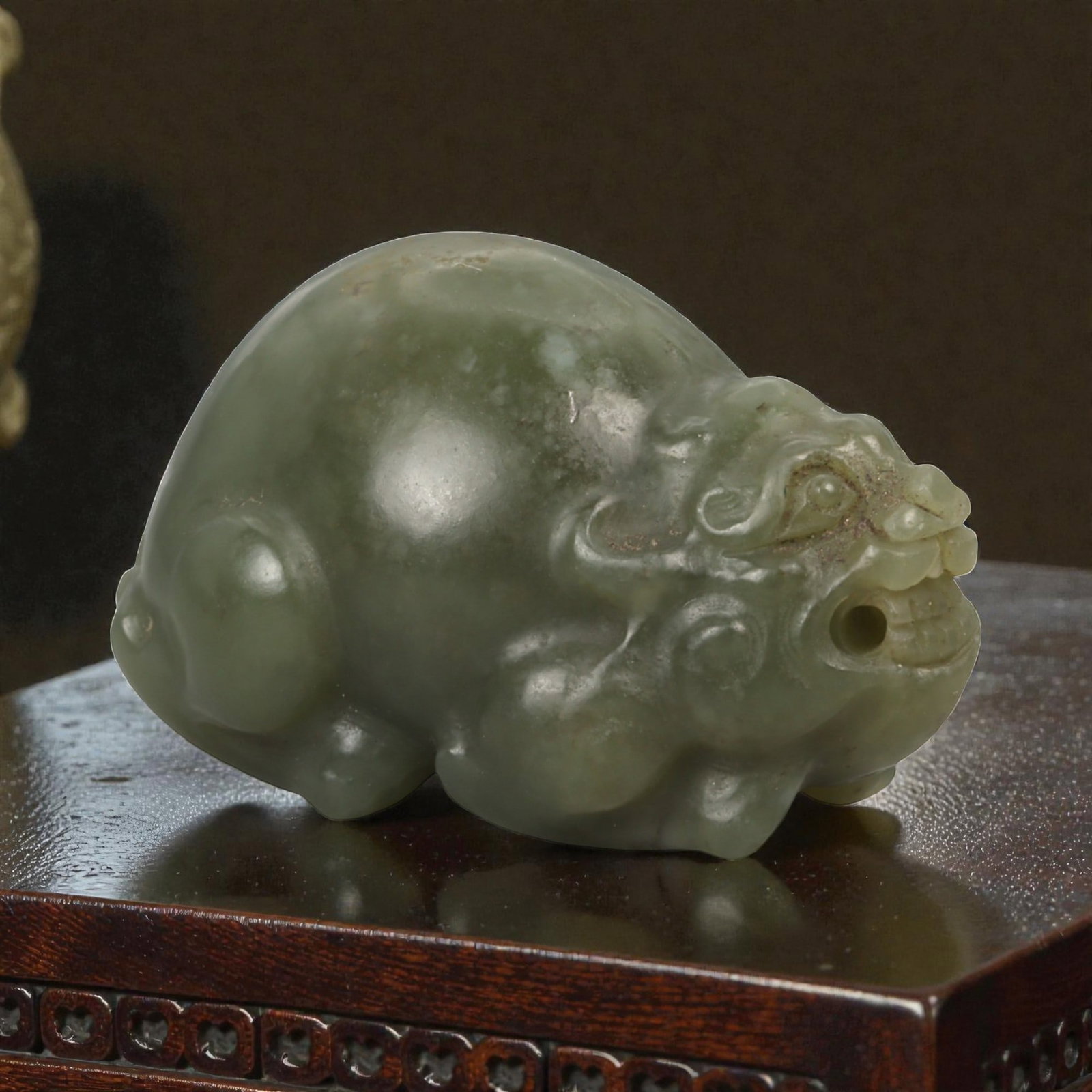 Chinese Jade Dragon-Headed Beast - Oriental Guardian Amulet, 57ZD: Carved from olive-green jade with a softly polished surface, this small sculptural amulet depicts a compact mythical creature with a dragon-like head and a rounded, crouching body. The head is modeled