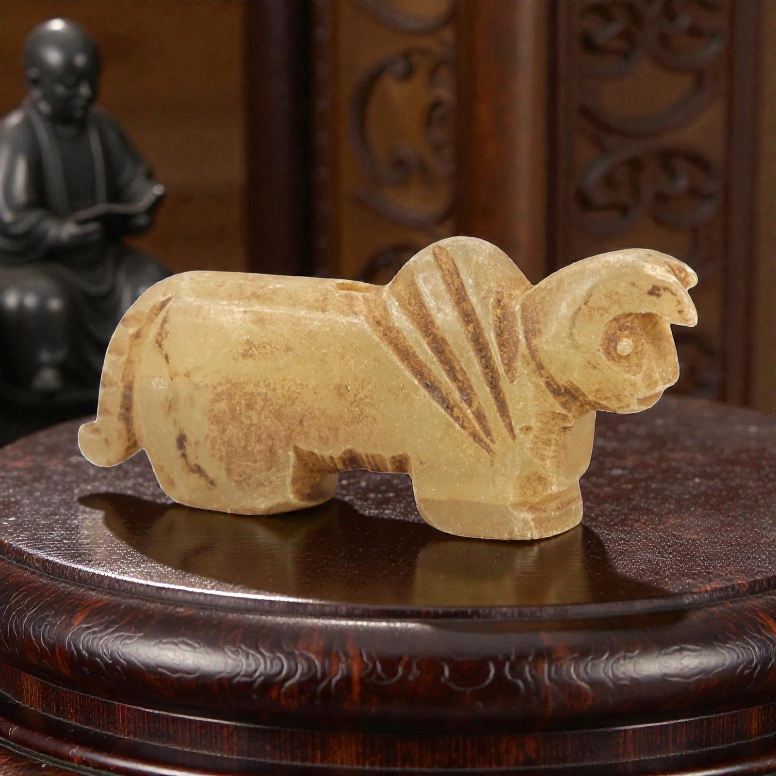 Ancient RockCrystal Bovid Amulet - Near Eastern Figurine, 87AL: Carved from translucent pale yellow rock crystal, this amulet depicts a stylized recumbent bovid, likely a ram or sheep, with incised linear patterns along the neck and back to denote fur or mane. The