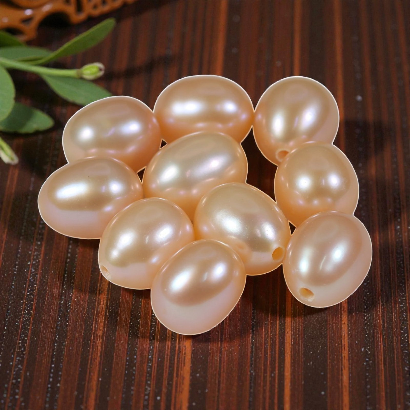 20.79ct Natural Fresh Water Pearl Drilled, 24YH: This is a drilled, natural freshwater pearl, showcasing a soft, warm peach-pink hue with a smooth, polished surface and gentle iridescence. The pearl features a classic oval shape with a consistent, e