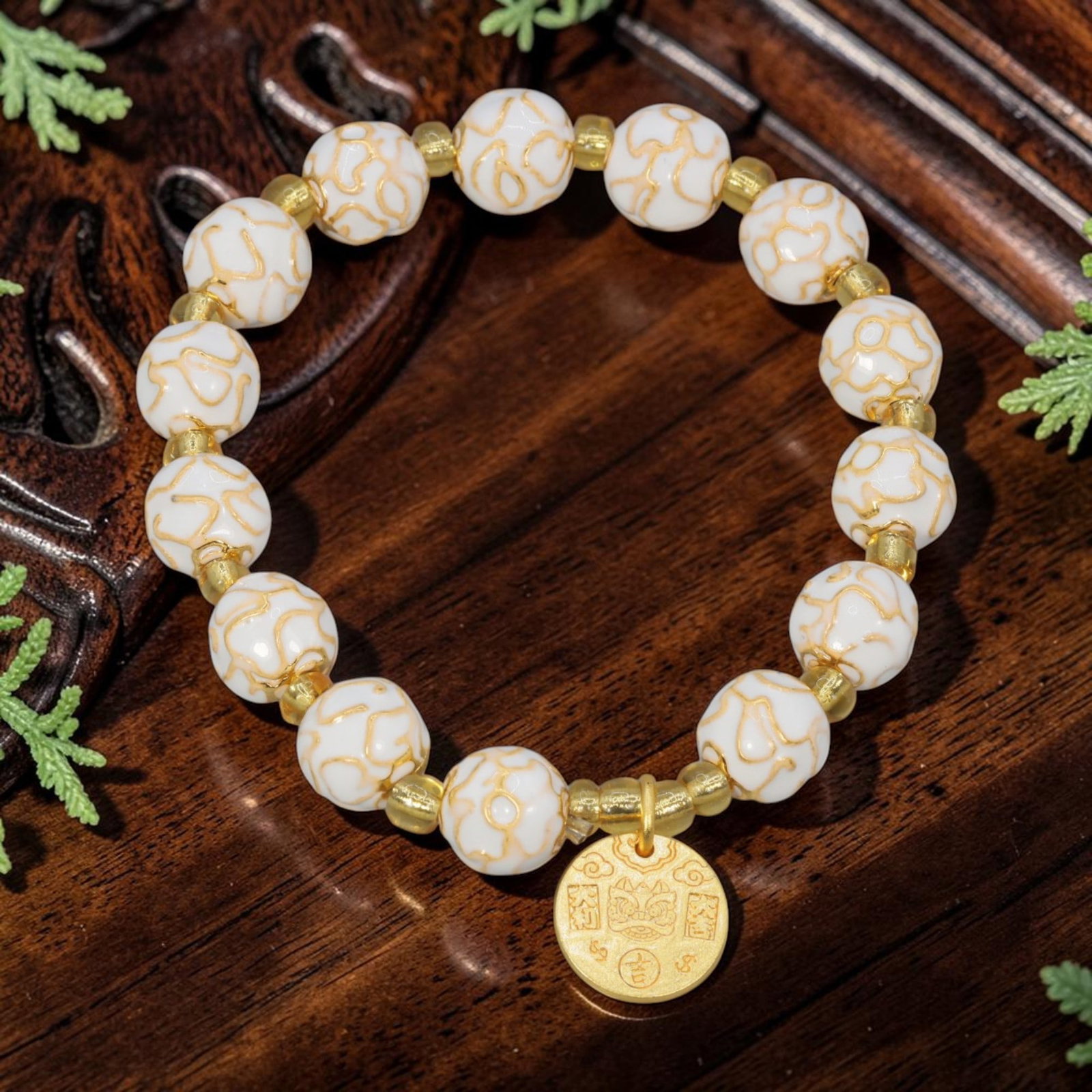 A Chinese Cloisonne Enamel Beaded Bracelet - White Gold-Tone Charm, 33YJ: This modern Chinese-style bracelet features 9.32mm round cloisonne enamel beads in a bright white hue, each detailed with raised gold-tone swirling patterns. Small smooth gold-tone spacer beads separa