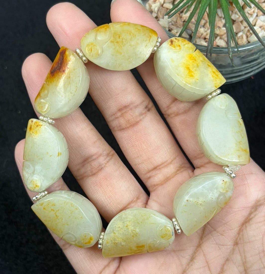 Natural Hetian Nephrite Jade Hand Carved Cicada Bracelet, Cicada Beads with Raw Yellow Skin, 25AS: Single strand handcrafted bracelet made of genuine Hetian nephrite jade, each focal bead finely carved into a lifelike cicada shape with dimensions 2.5cm x 1.5cm. The pale creamy white jade retains na