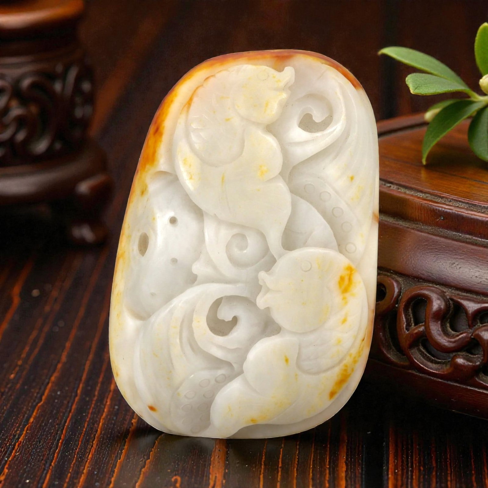 A Chinese Hetian Nephrite Jade Pebble with Fish Carvings, 20th Century, 22YB: Carved from a natural Hetian nephrite river pebble of creamy white tone with areas of warm russet skin preserved along the edges, the piece is worked in shallow relief while retaining the rounded, org