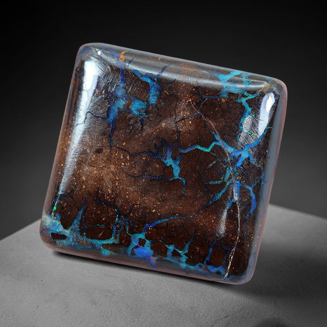 18.21ct Natural Australian Queensland Matrix Boulder Opal Cabochon, 12AV: Hand polished compact rounded square cushion cabochon formed from natural Queensland matrix boulder opal, featuring warm speckled brown ironstone host matrix crisscrossed with intricate branching opal
