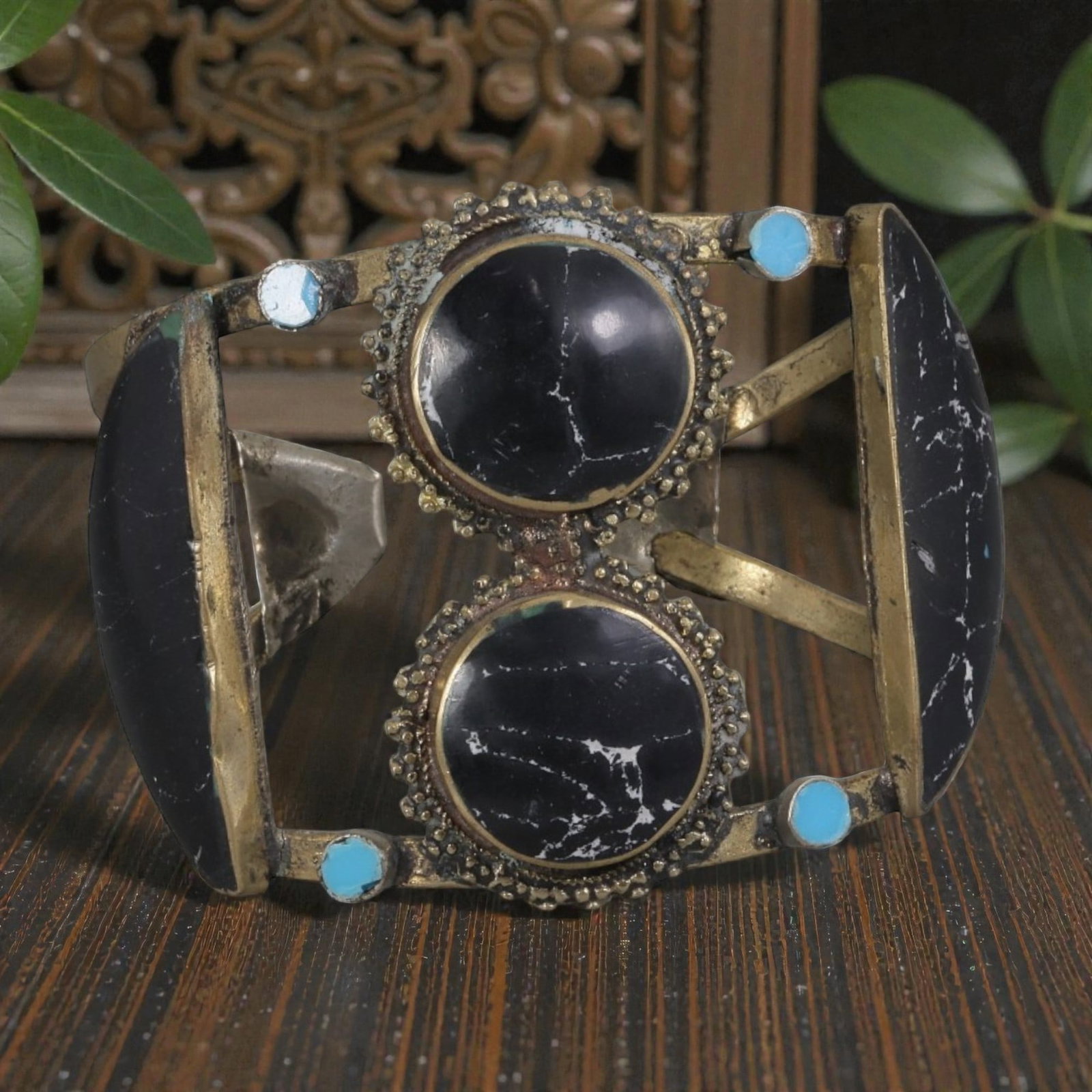 A Vintage Himalayan Stone Inlay Cuff Bracelet, 58AH: A handcrafted vintage cuff bracelet, measuring approximately 6 cm in width, showcasing traditional Himalayan jewelry design. The piece features a mixed metal base (likely brass or bronze) with ornate 