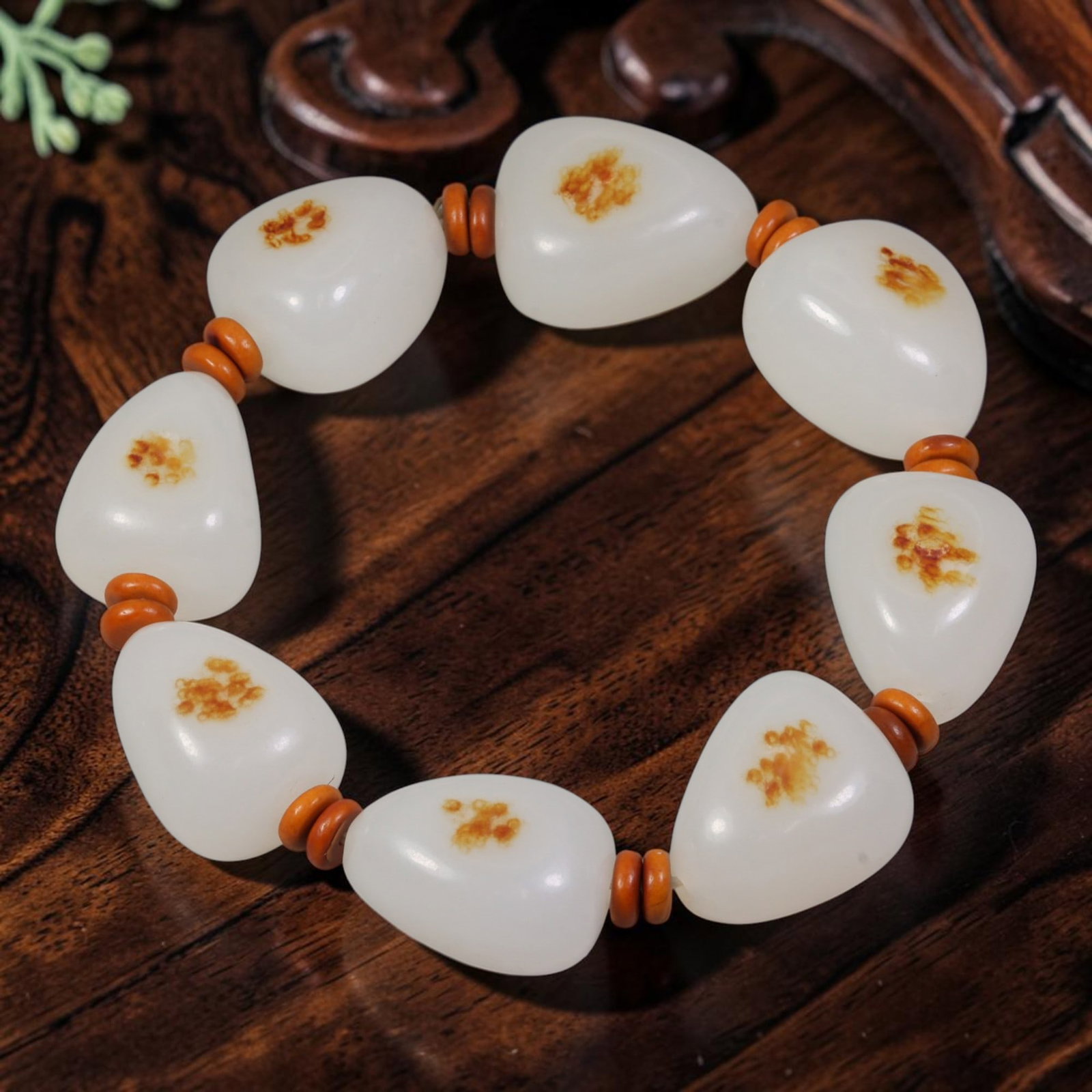 Chinese Hetian Nephrite White Seed Pebble Bracelet - Natural Russet Skin, 52YJ: This bracelet is strung from natural, uncarved Hetian nephrite white seed pebble jade stones, each retaining organic river-worn teardrop and oval shapes with a soft milky white base tone. Each stone f