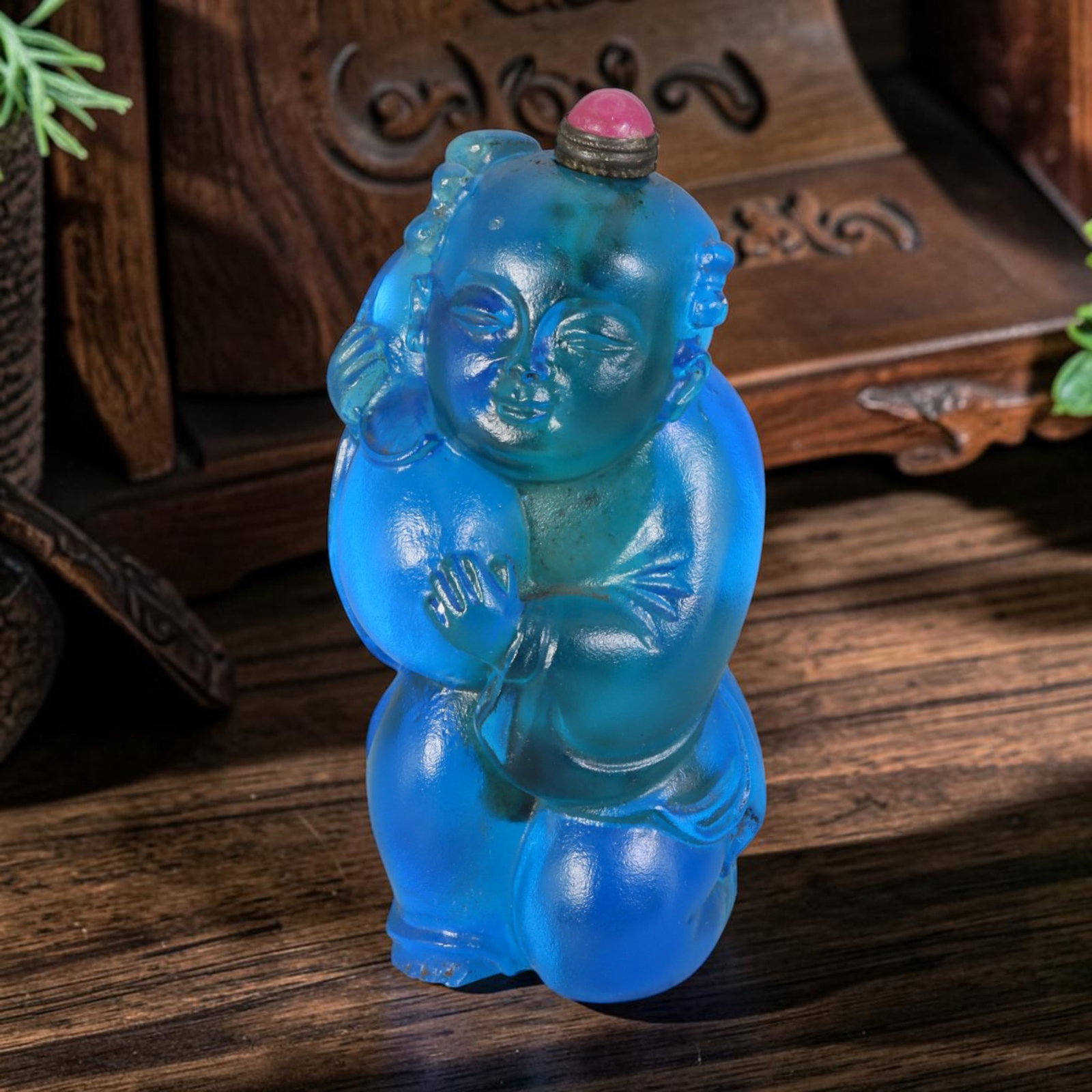 Vintage Chinese Liuli Glass Snuff Bottle - Carved Child Holding Peach Figurine Vessel, 39AS: This fully sculpted anthropomorphic snuff bottle is formed from translucent vivid sky-blue frosted vintage Chinese liuli glass, shaped as a traditional kneeling Chinese child figure styled with side h