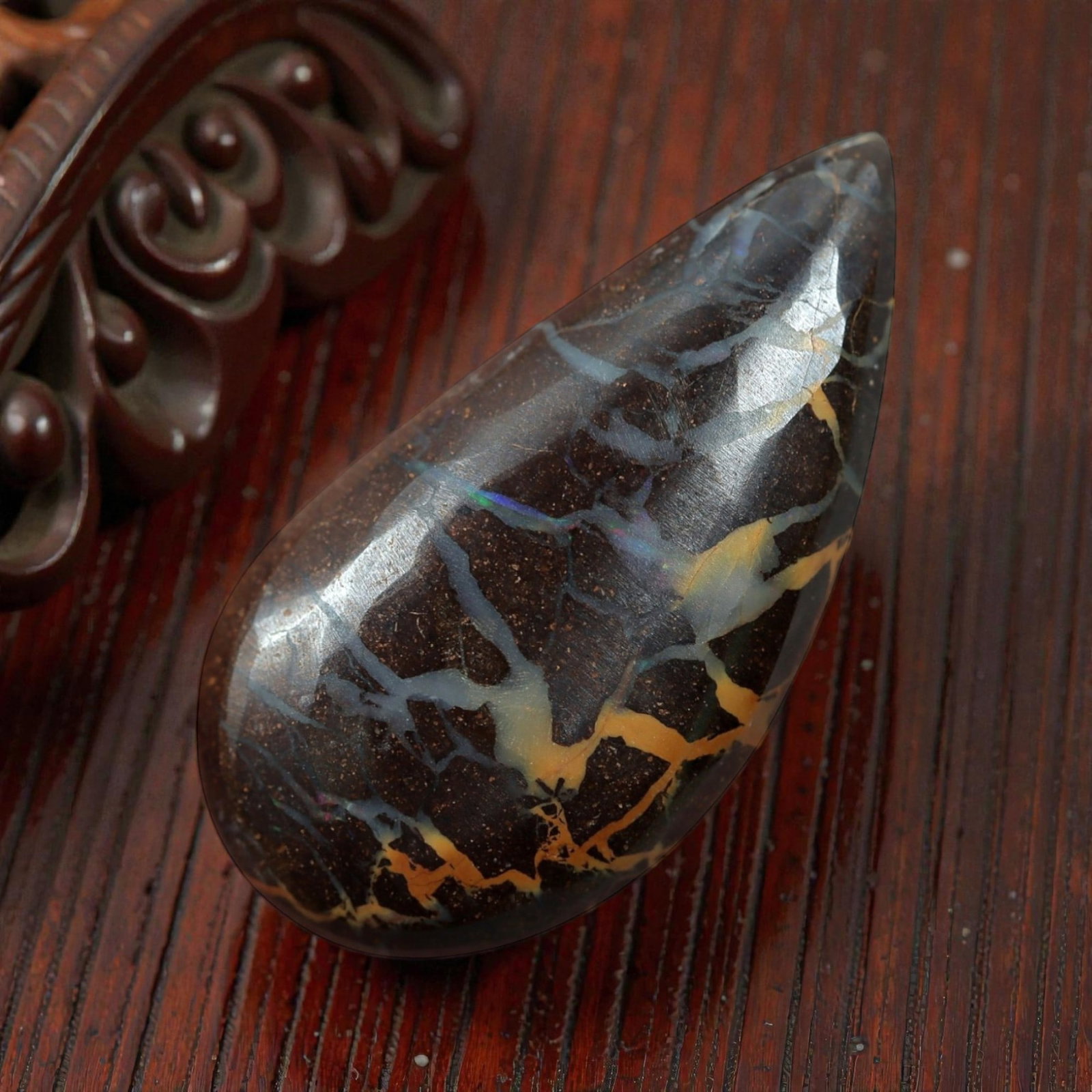 5.45 Carats Boulder Opal Cabochon - Natural Matrix Vein, 61XM: This 5.45ct boulder opal cabochon, measuring 18x9mm, is a striking example of Australia's iconic gemstone, showcasing the unique beauty of nature's artistry. The teardrop-shaped cabochon is polished t