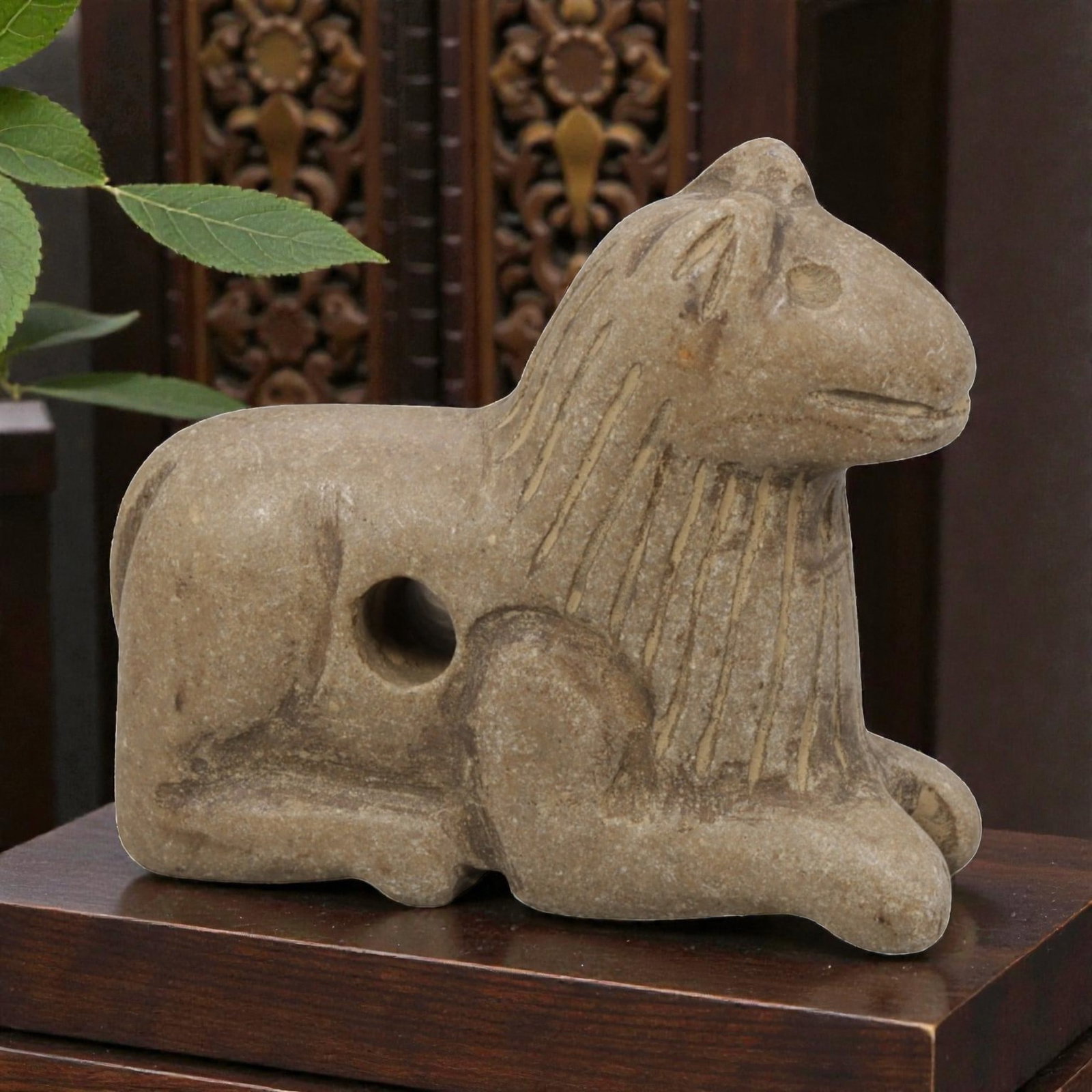 Ancient Near Eastern Style Stone Recumbent Feline Amulet, 90WM: A single ancient Near Eastern-style stone amulet, carved in the form of a recumbent feline (likely a lion or similar big cat). The piece features stylized incised lines representing the mane, simple c