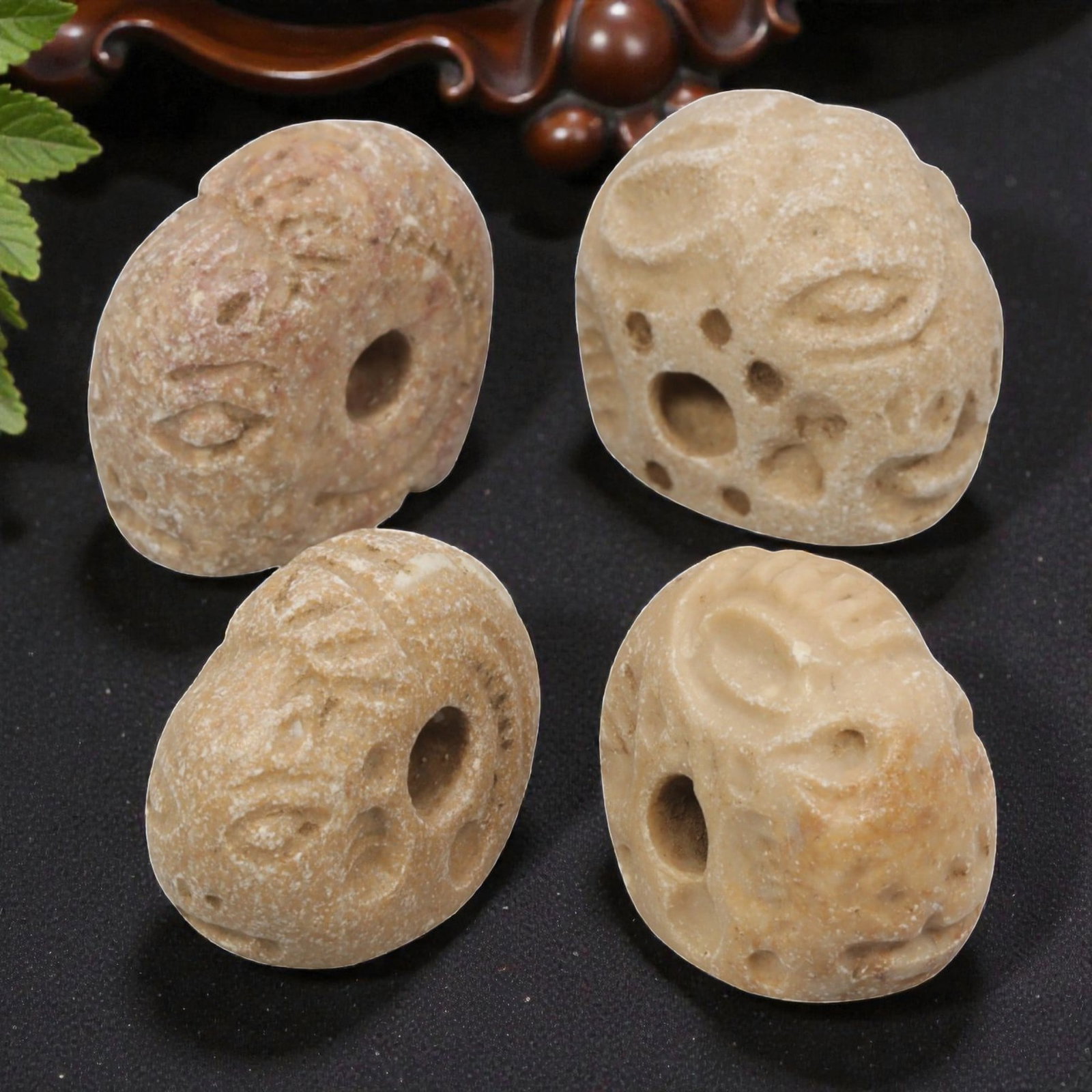 Lot of 4 Ancient Sasanian Anthropomorphic Stone Stamp Seals, 87WT: Carved from light-colored stone with natural variations in tone, the group consists of four distinct anthropomorphic stamp seals. Each piece features a rounded, bead-like form with stylized facial mot