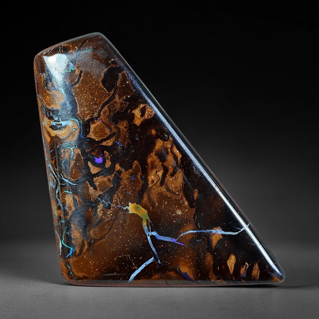 12.26ct Natural Australian Queensland Matrix Boulder Opal Freeform Wedge Triangular Cabochon, 68AV: Hand polished asymmetrical freeform wedge triangle cabochon crafted from natural Queensland matrix boulder opal, featuring glitter-flecked warm caramel brown ironstone matrix woven with swirling orbic