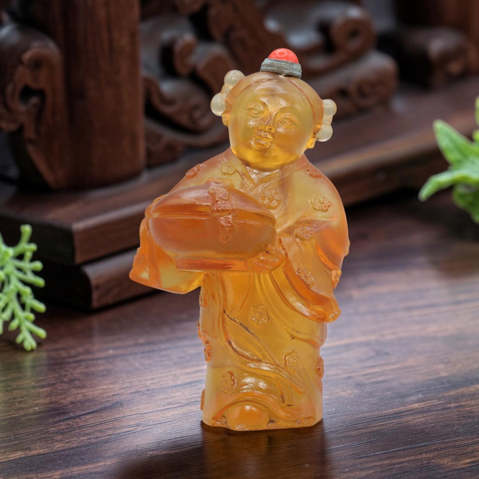 Vintage Chinese Yellow Liuli Snuff Bottle - Child Figure, 61YF: Crafted from translucent amber-toned liuli glass, this snuff bottle depicts a standing child figure in traditional attire, holding a covered offering box with both hands. The child's robe is adorned w