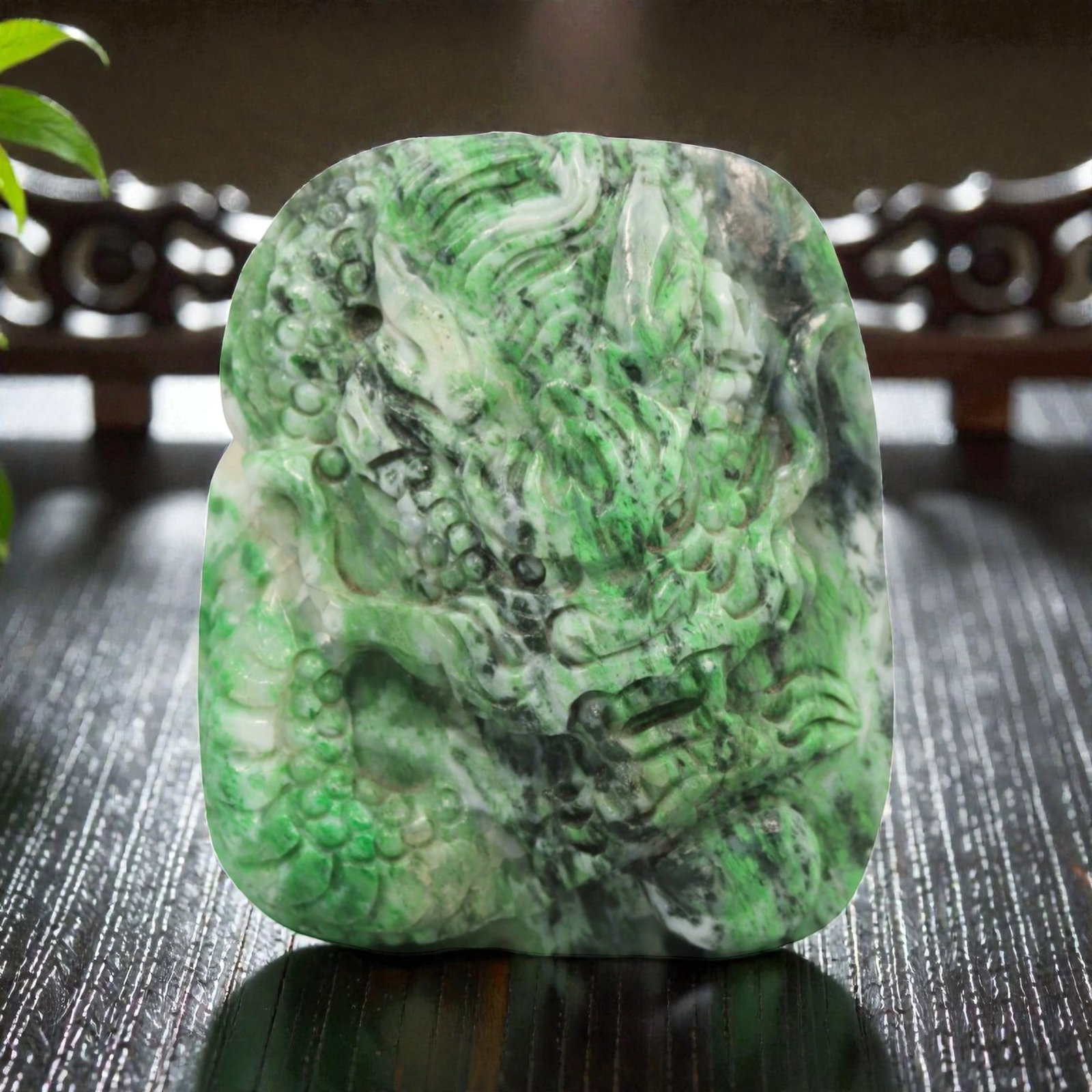 Natural Burmese Type A Jadeite Jade Pendant, 20th Century, 14ZL: Carved from green jadeite jade with natural dark green and greyish inclusions distributed throughout the matrix, the pendant is formed as an irregularly rectangular object with a relief-carved dragon 