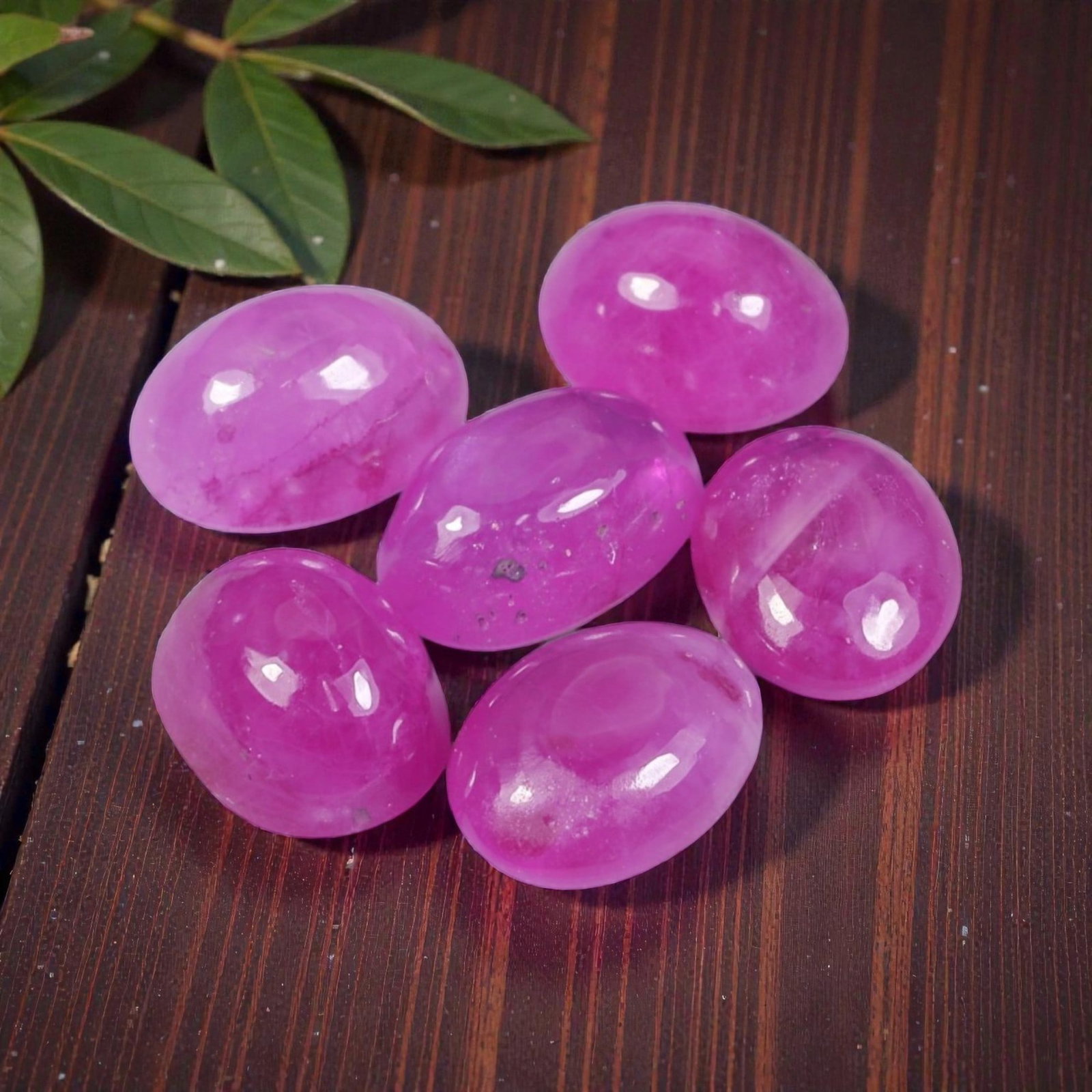 5.42 Carats Natural Ruby - Oval Cabochon Gemstone, 97WE: Oval cabochon-cut ruby gemstone, crafted from natural ruby material. The stone exhibits a vivid, saturated pinkish-magenta hue, with subtle natural inclusions, internal veining, and minor surface text