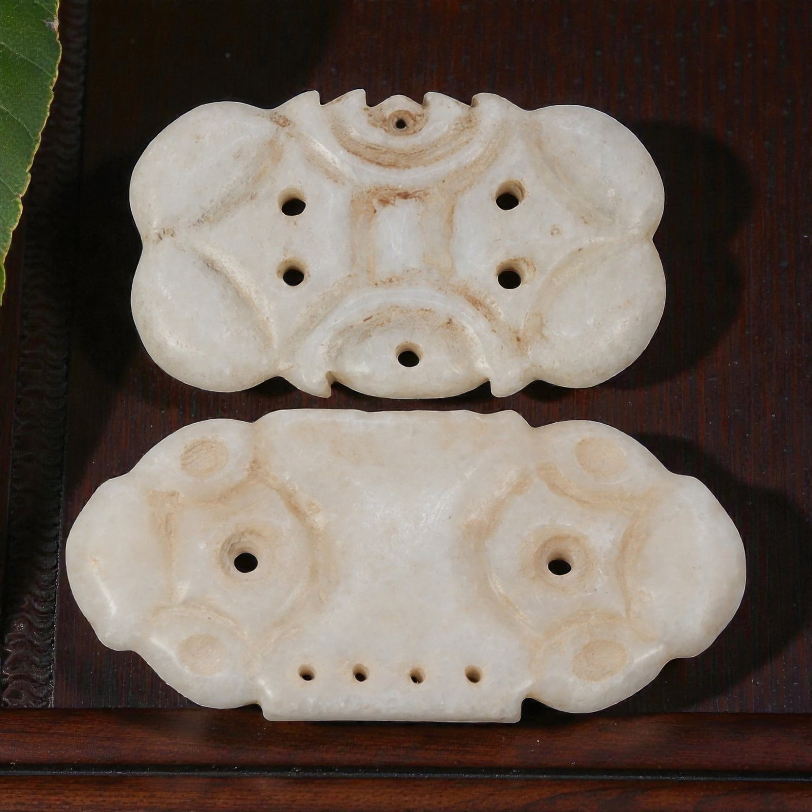 Lot of 2 Ancient Near Eastern Marble Ornamental Amulets, c. Iron Age to Sasanian Period, 93WK: A pair of finely carved marble ornamental plaques from the Ancient Near East, featuring symmetrical geometric designs with multiple perforations for suspension. Crafted from smooth white marble with s