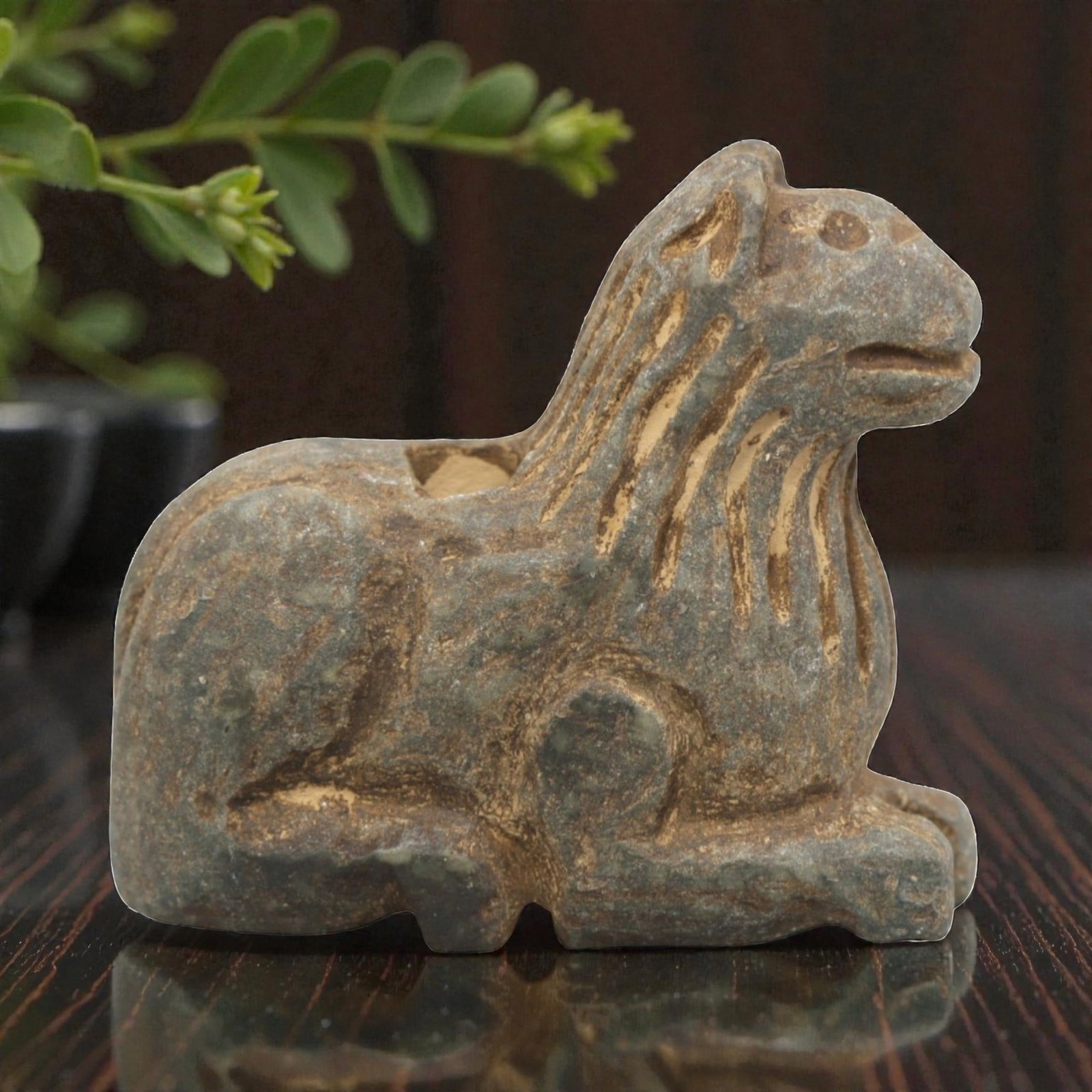 Ancient Stone Feline Amulet - Near Eastern Recumbent, 45ZR: Carved from muted green-grey stone with a naturally weathered, earthy patina, executed in a stylized recumbent form characteristic of Near Eastern zoomorphic amulet craftsmanship. The figure depicts a