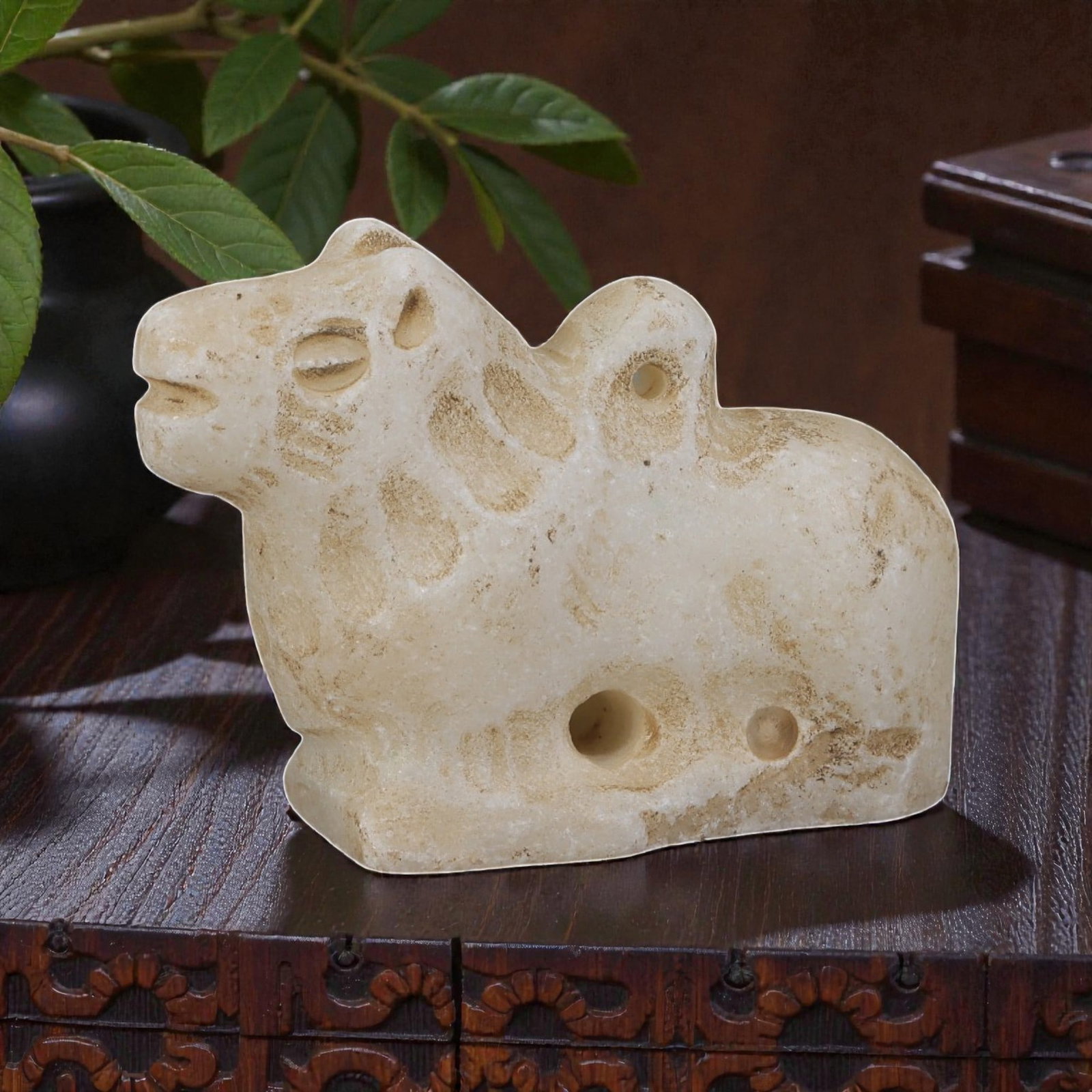 Ancient Bactrian Zoomorphic Marble Amulet, Circa 3rd-2nd Millennium BCE, 92YD: This ancient zoomorphic amulet is carved from pale, creamy marble, depicting a stylized recumbent quadruped, likely a camel or bovine figure, in profile. The form features simplified anatomical detail