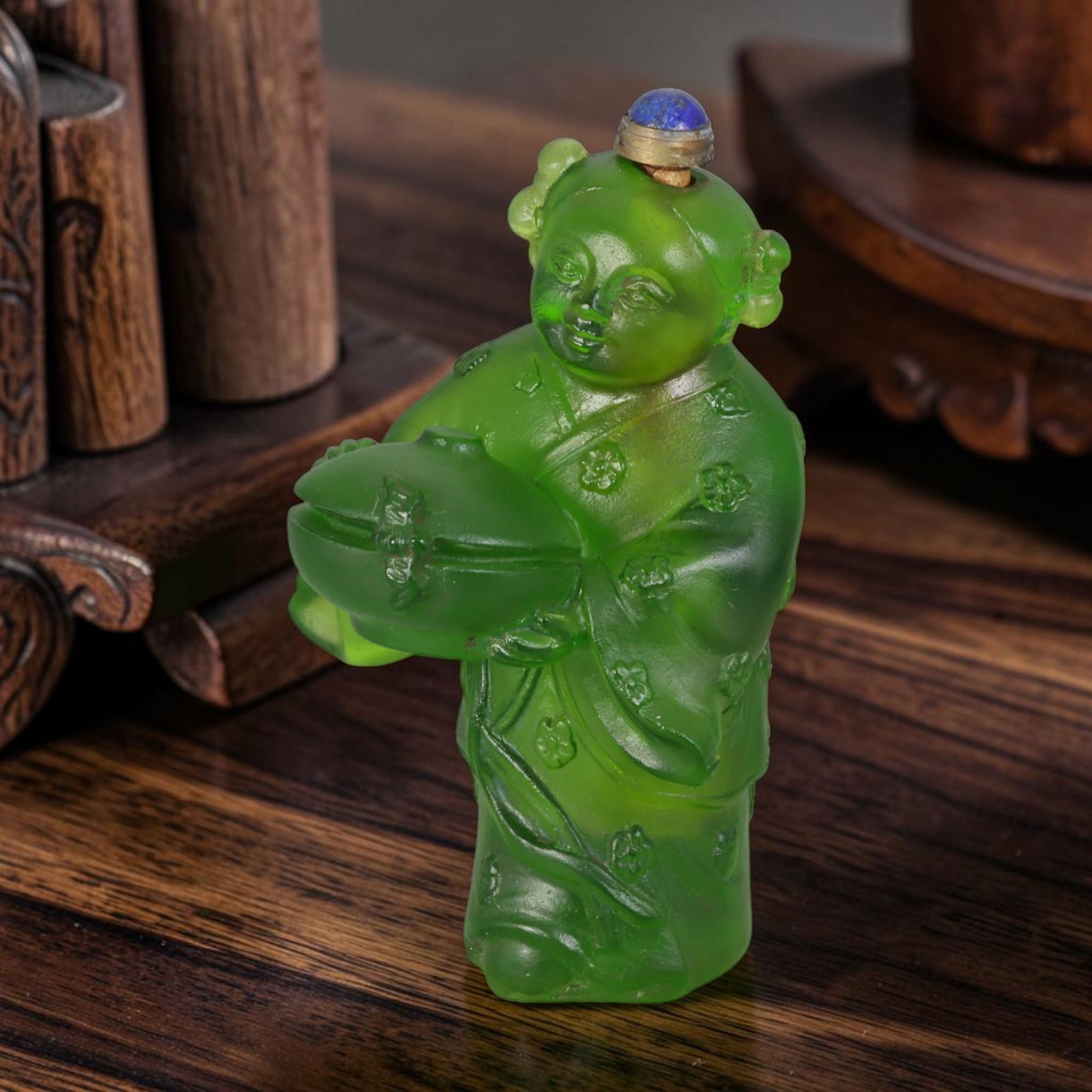 Vintage Chinese Liuli Glass Snuff Bottle - Carved Child With Clam Figurine Vessel, 33AS: This fully sculpted anthropomorphic snuff bottle is formed from translucent emerald frosted vintage Chinese liuli glass, shaped as a traditional Chinese child figure styled with double hair buns and e