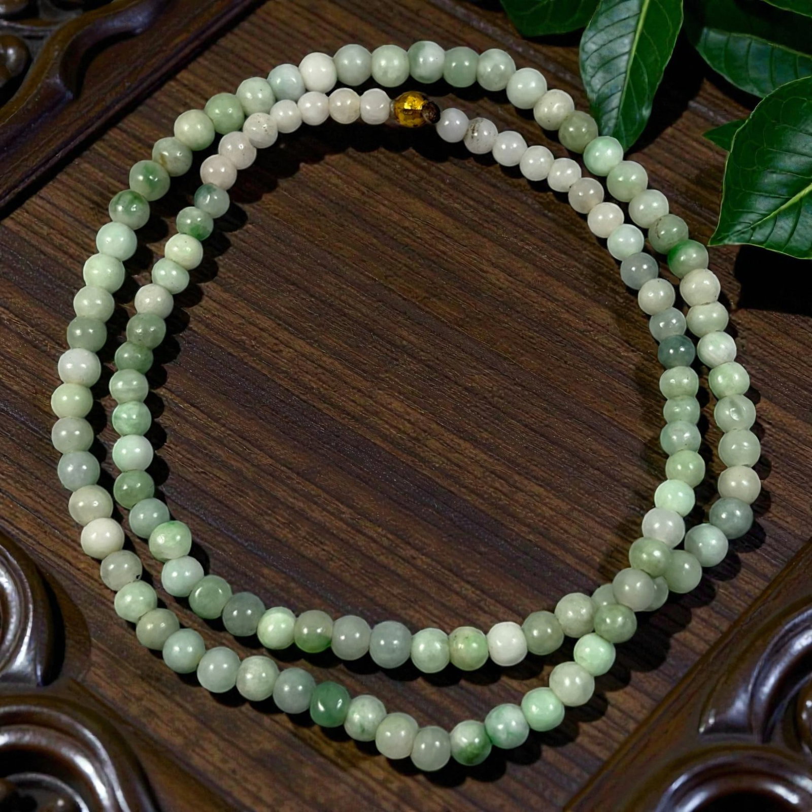 Natural Burmese Type A Jadeite Jade Bead Necklace, 29YG: A continuous strand of uniformly spherical polished jadeite beads displaying blended pale green, milky white and muted grey natural coloration with inherent mineral inclusions and gentle tonal variati