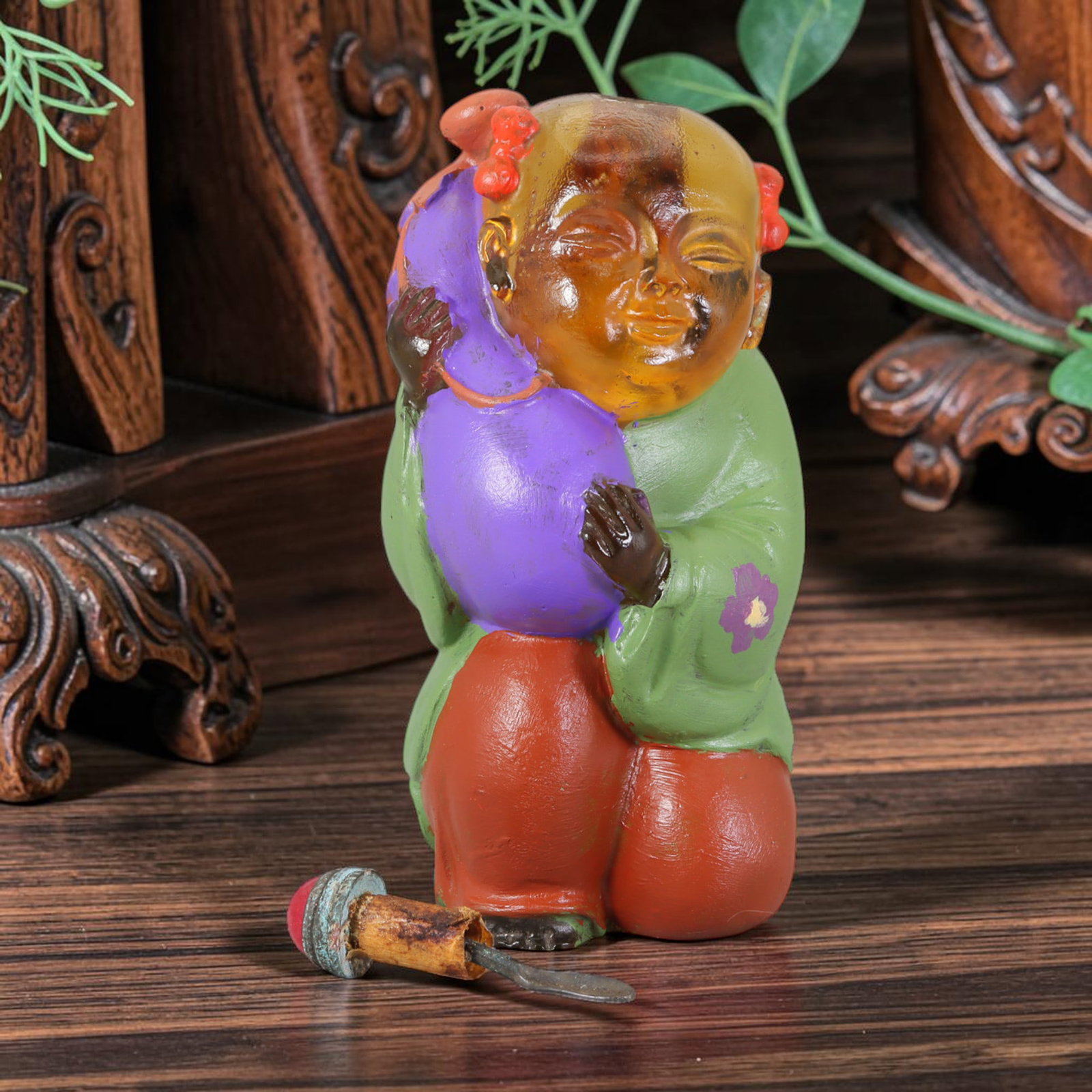 Vintage Chinese Liuli Glass Snuff Bottle - Girl with Melon, 54AS: This snuff bottle is moulded from translucent amber liuli glass, shaped as a young girl clutching a melon. The robe and fruit receive hand-painted enamel colouring with small floral accents, showing c