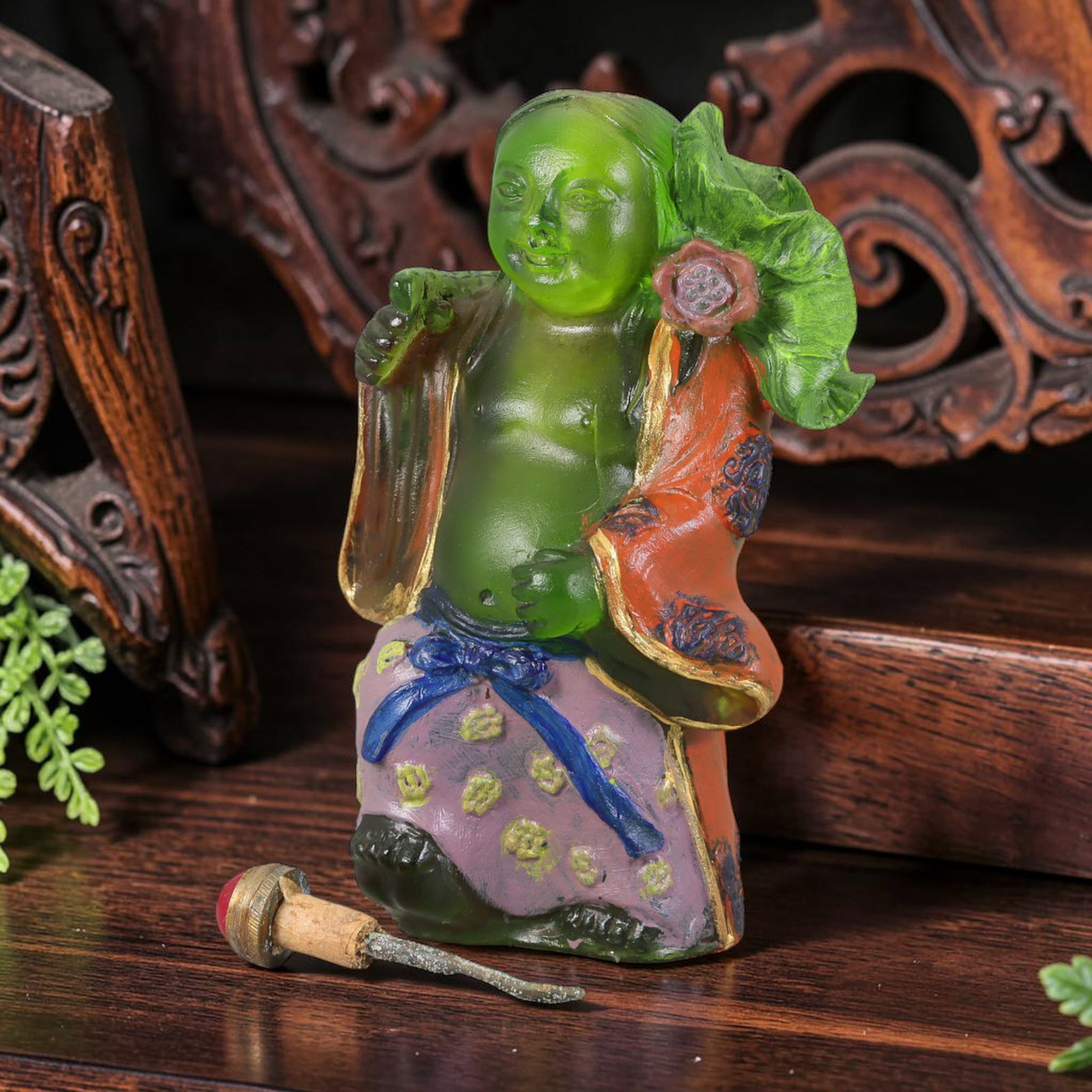 Vintage Chinese Liuli Glass Snuff Bottle - He-He Immortal Figure, 47AS: This snuff bottle is moulded from translucent green liuli glass, shaped as a He-He immortal holding a lotus leaf and flower. The open robe features gilded trim with painted dark floral patterns, while