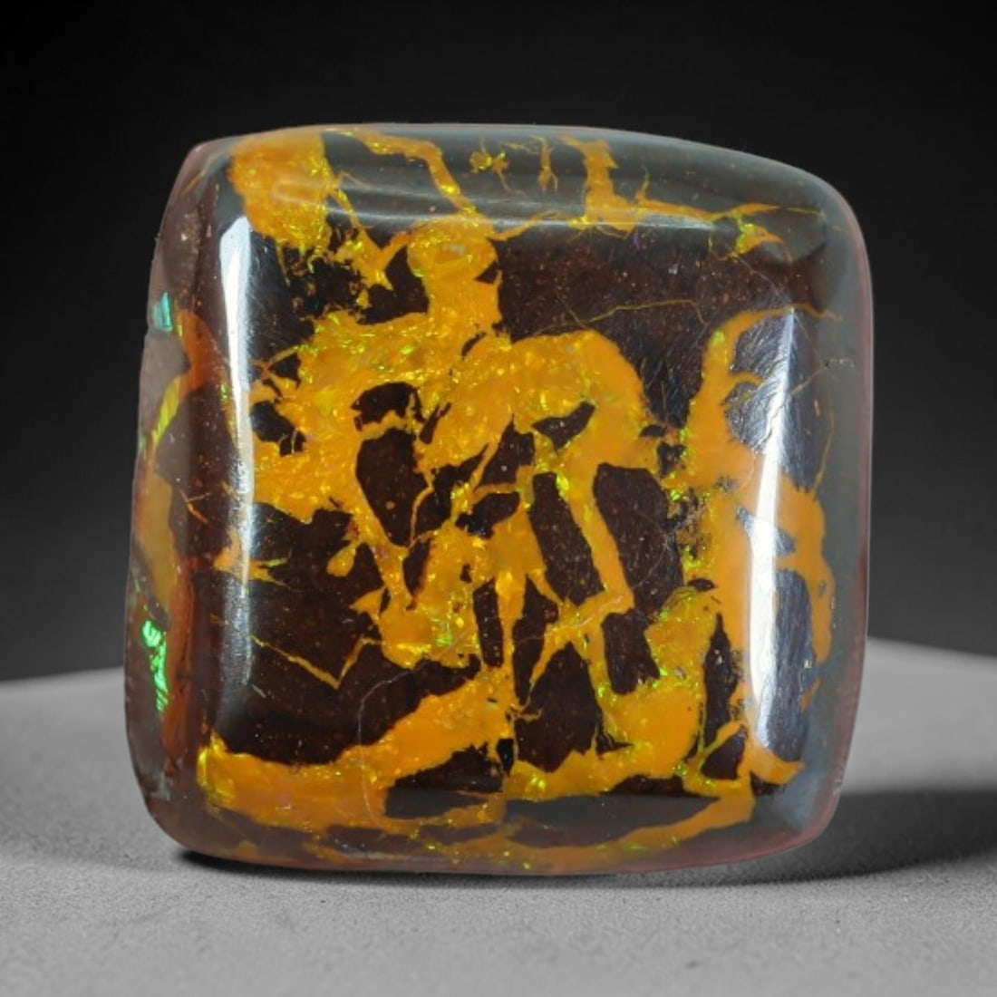 12.80ct Natural Australian Queensland Matrix Boulder Opal Cabochon, 78AT: This polished cushion cabochon is a natural matrix boulder opal mined in Queensland, Australia, formed with dark ironstone host matrix veined with vibrant golden opal flash flecked with subtle green i