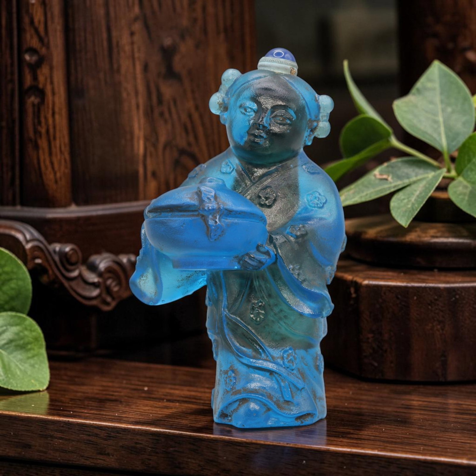 Vintage Chinese Liuli Glass Figurine - Blue Snuff Bottle Attendant, 59YF: Crafted from translucent blue liuli glass with a matte finish, depicting a standing attendant figure in traditional robes holding a covered box. The figure features detailed floral patterns on the rob