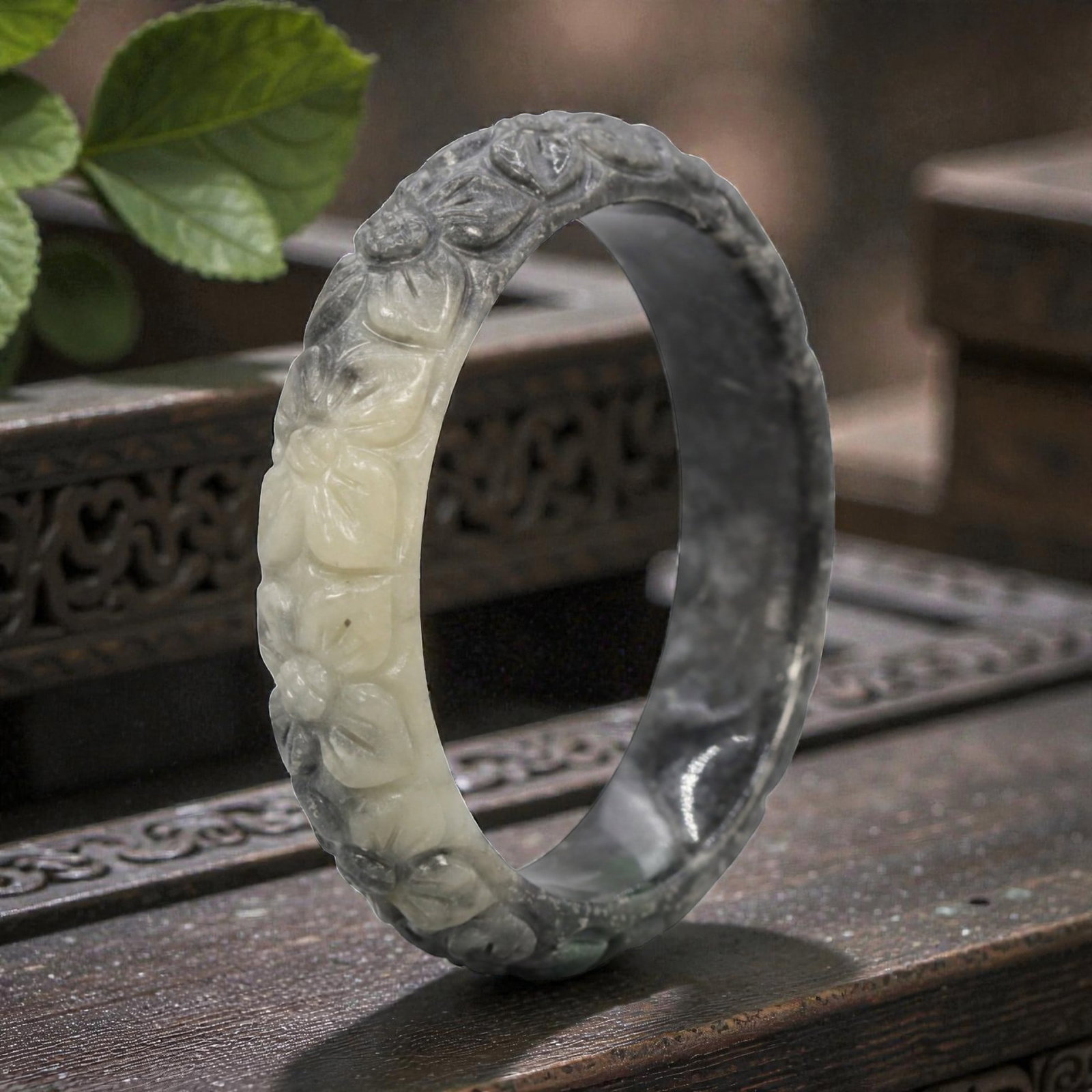 Natural Burmese Type A Carved Jadeite Jade Bangle Bracelet, 20th Century, 47ZL: A fine jadeite bangle of flattened circular form, masterfully carved in relief with a continuous band of floral blossoms and scrolling foliate motifs. The stone exhibits a striking variegated palette,