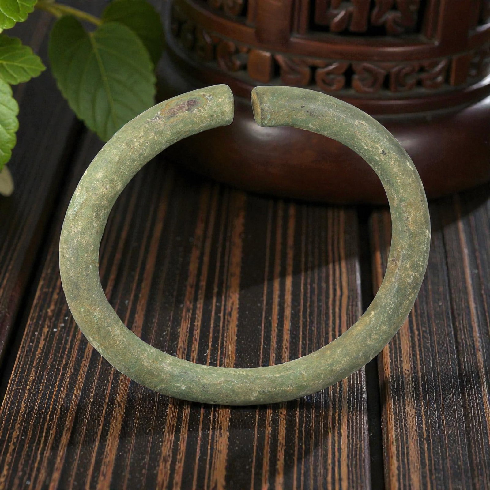 Ancient Roman Bronze Bracelet - Open Cuff Form, 35BN: Crafted from bronze, this open bracelet is formed as a thick, rounded rod creating a near-circular cuff with a narrow gap between the flat terminals. The surface displays a rich, uneven patina of gree