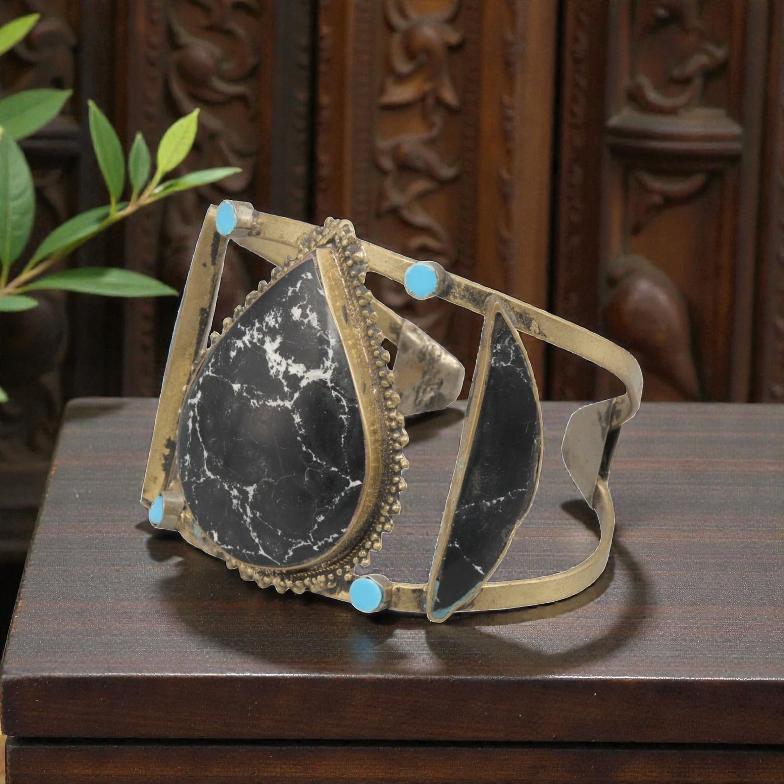 A Vintage Himalayan Stone Inlay Cuff Bracelet, 30AH: A handcrafted vintage cuff bracelet, measuring approximately 7 cm in width, featuring traditional Himalayan jewelry design. The piece has a brass-toned metal base, showcasing a large teardrop-shaped b