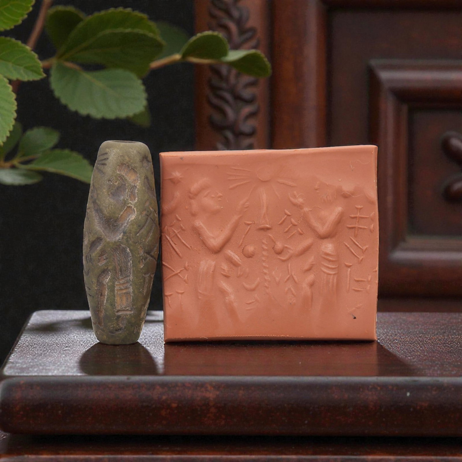 Ancient Steatite Cylinder Seal - Mesopotamian Sacred Tree & Cuneiform Scene, 60AN: Carved from dense steatite, this ancient Mesopotamian cylinder seal features a detailed linear relief composition of two human figures flanking a central sacred tree, interspersed with cuneiform inscr
