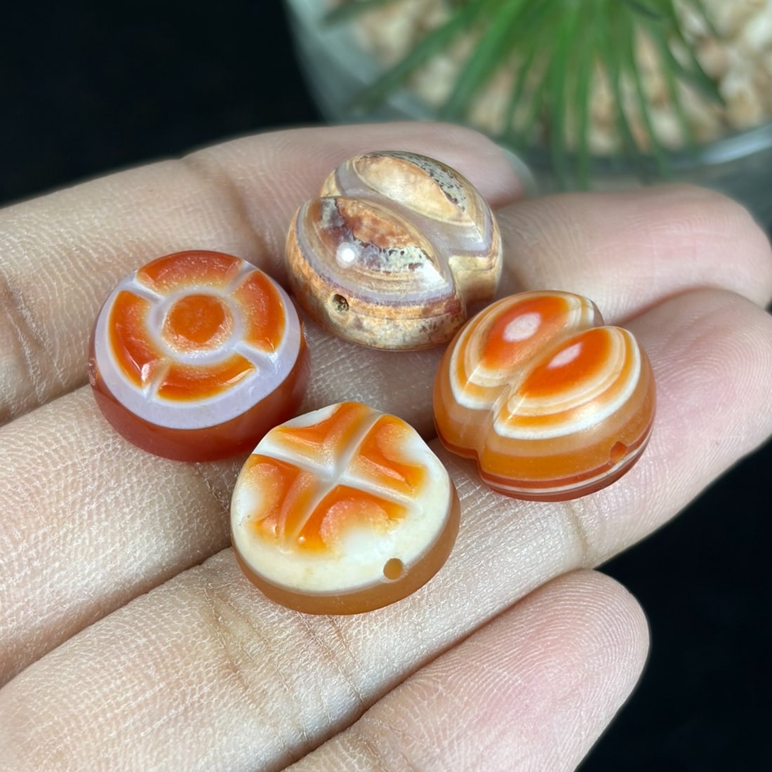 Vintage Carnelian Agate Beads - Tibetan Carved Mini Amulet Lot, 72AR: Crafted from natural banded carnelian agate, this set of four miniature beads features traditional Tibetan symbolic relief carving, each specimen displaying distinct natural orange-and-white banded ag
