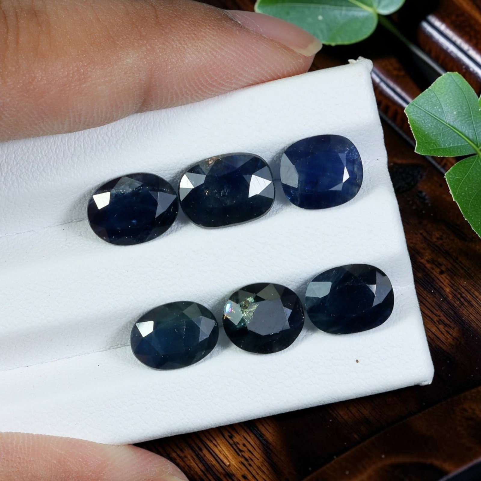 15.66 Carats Natural Blue Sapphire Mixed Oval & Cushion Faceted Parcel, 94WC: This parcel includes six professionally faceted natural blue sapphires displaying deep saturated navy blue tones with subtle natural color zoning and slight shade variation across individual stones, c