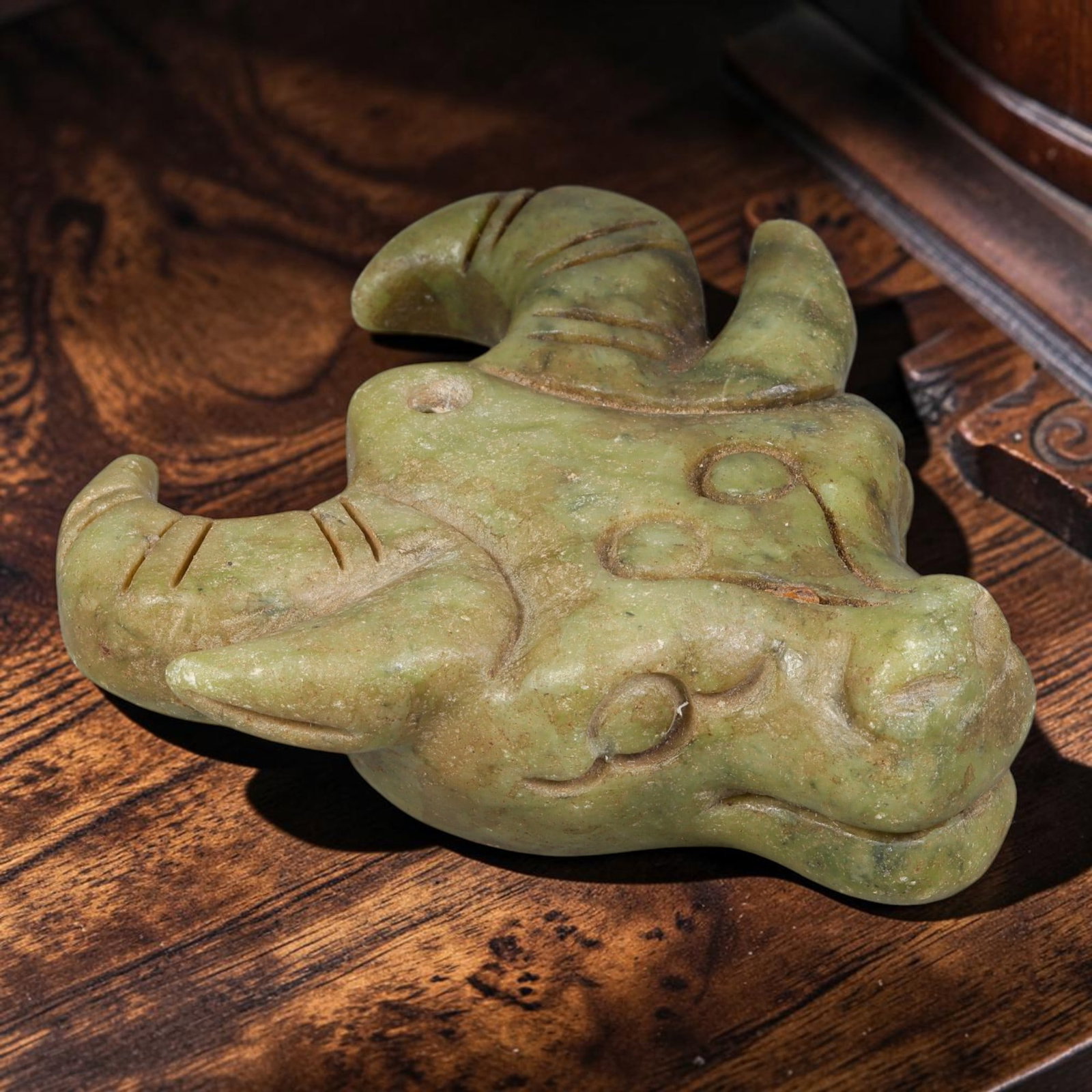 Chinese Jade Buffalo Head - Carved Pendant Figurine, 73AS: Carved from solid Chinese jade, this piece features hand-chiseled detailing executed with traditional Chinese jade carving techniques, defining the rounded cranial structure, facial features, and curv
